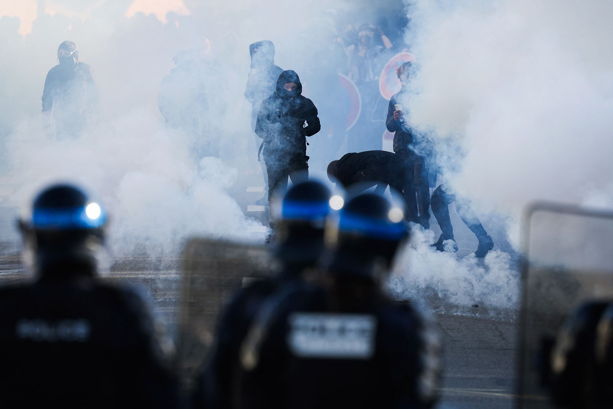 Police officers fire tear gas at protesting students near the Kerichen high school in Brest, France, on Friday.