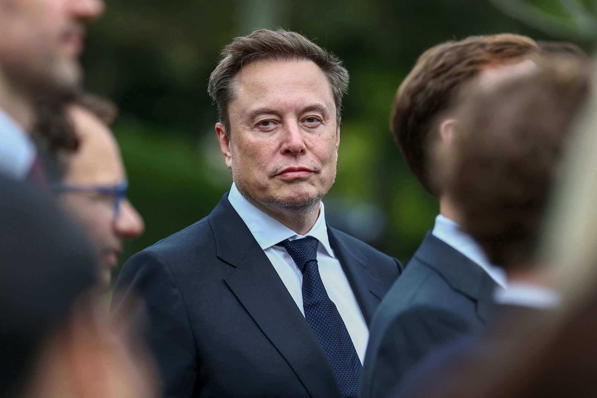 Elon Musk attends a press briefing by President Donald Trump with AI executives following a meeting on AI at the White House in 2026.