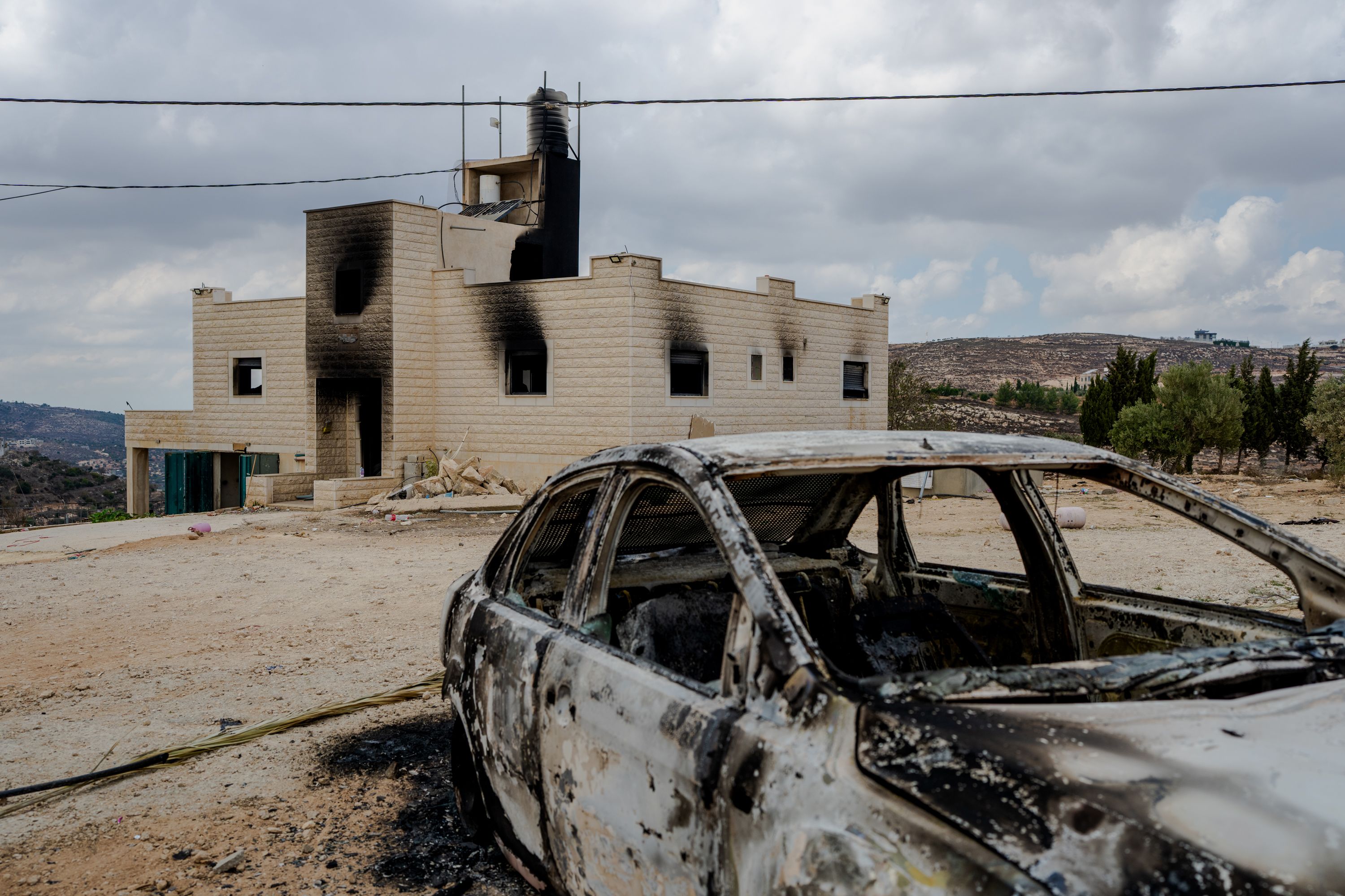 A destroyed car sits outside a burnt house after Israeli settlers attacked the Tubasi family and Israeli security forces who were escorting them back to their home in Jalud. (Photo by Erik Marmor/Getty Images)