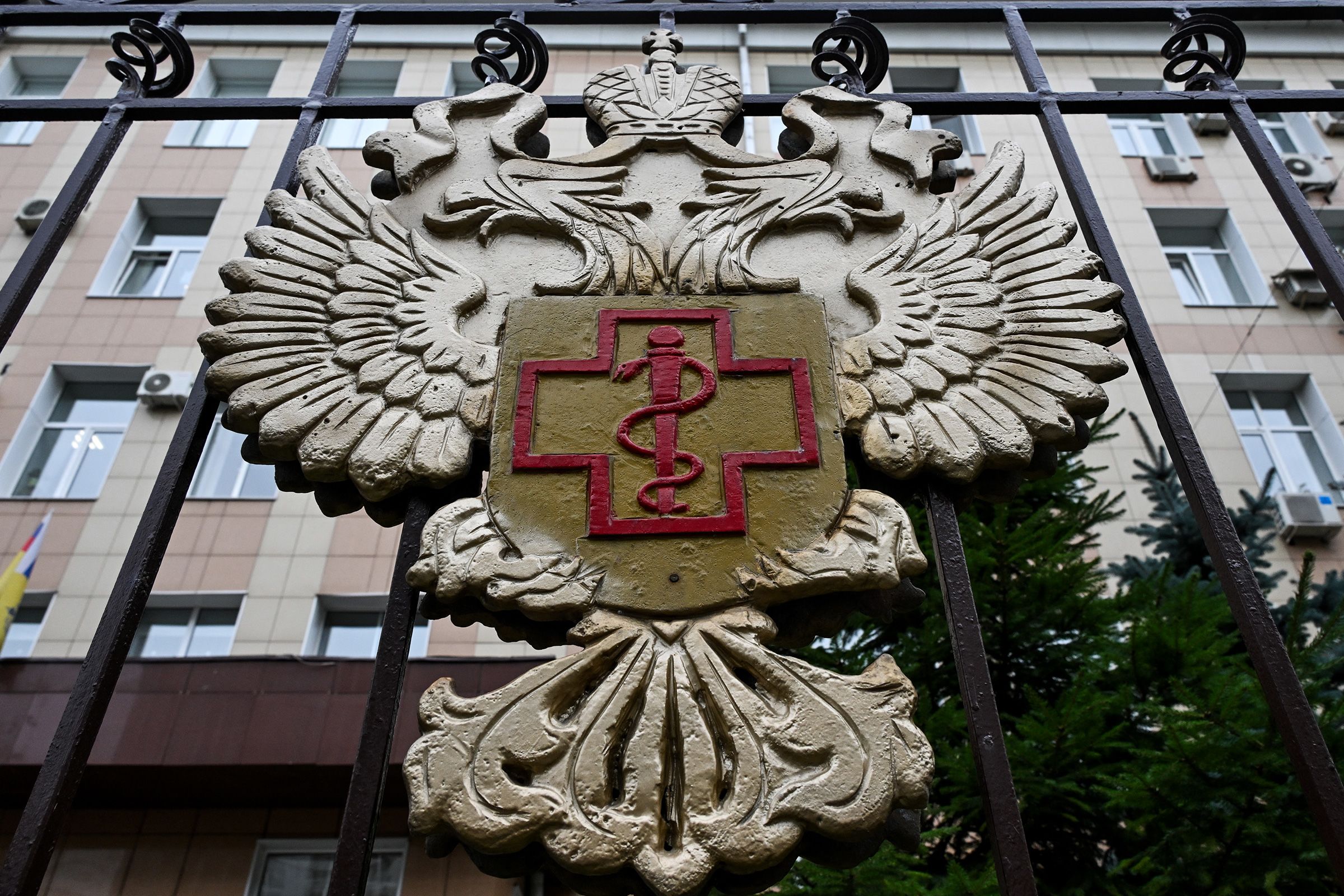 The logo of Rospotrebnadzor, the Russian agency that handles infectious disease, sits on the fencing of its grounds in Moscow on Monday.