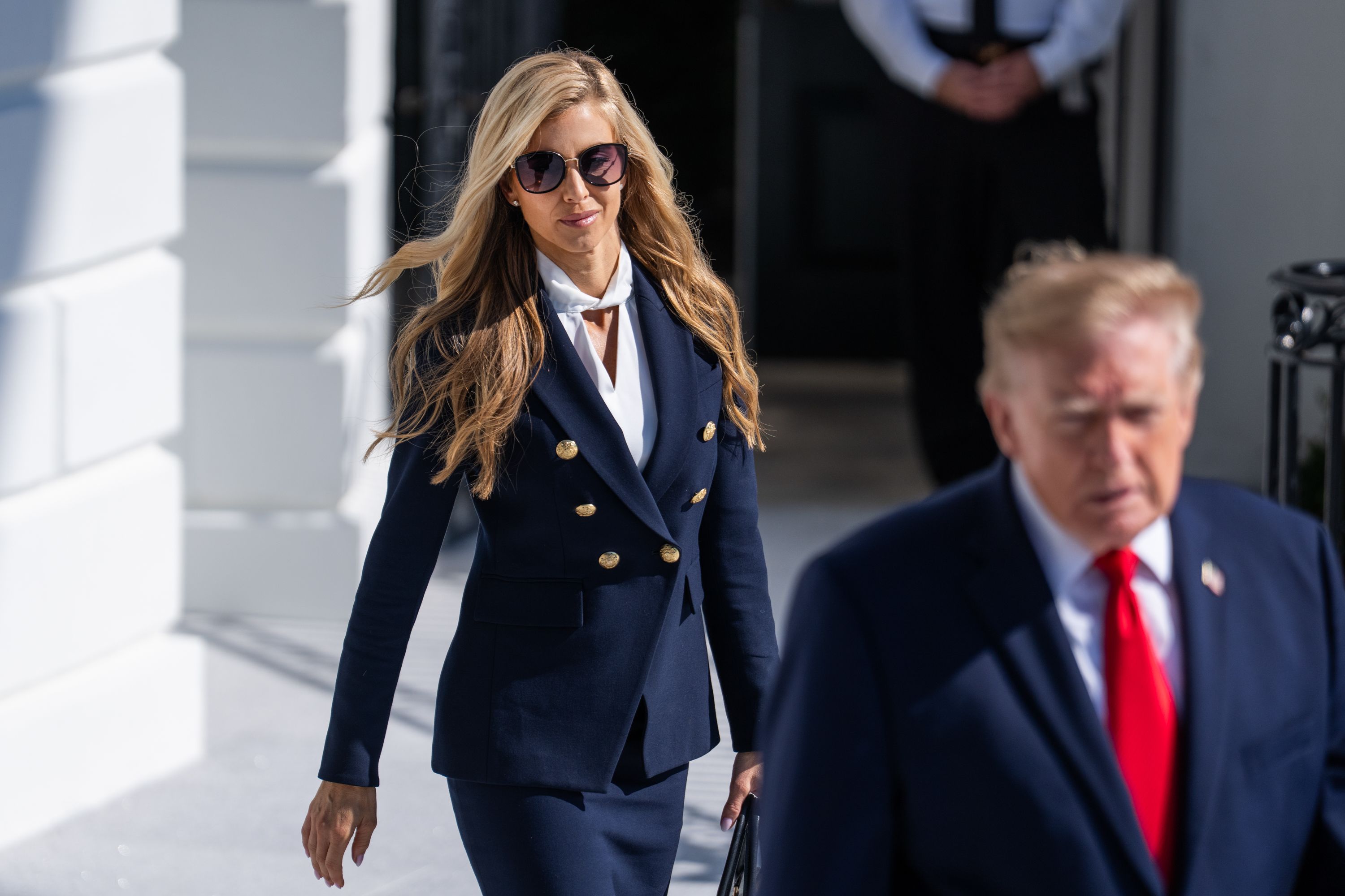 President Donald Trump and White House Press Secretary Katie Zacharia arrive to the South Lawn of the White House before boarding Marine One en route to Alaska on Tuesday, October 13, 2026.