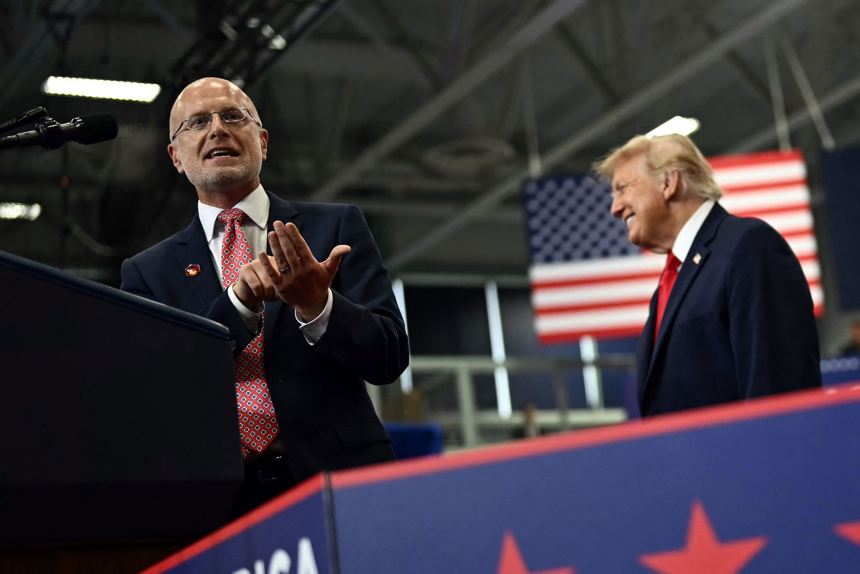 President Donald Trump reacts as FCC chairman Brendan Carr speaks during a campaign rally in Wasilla, Alaska, on October 13.