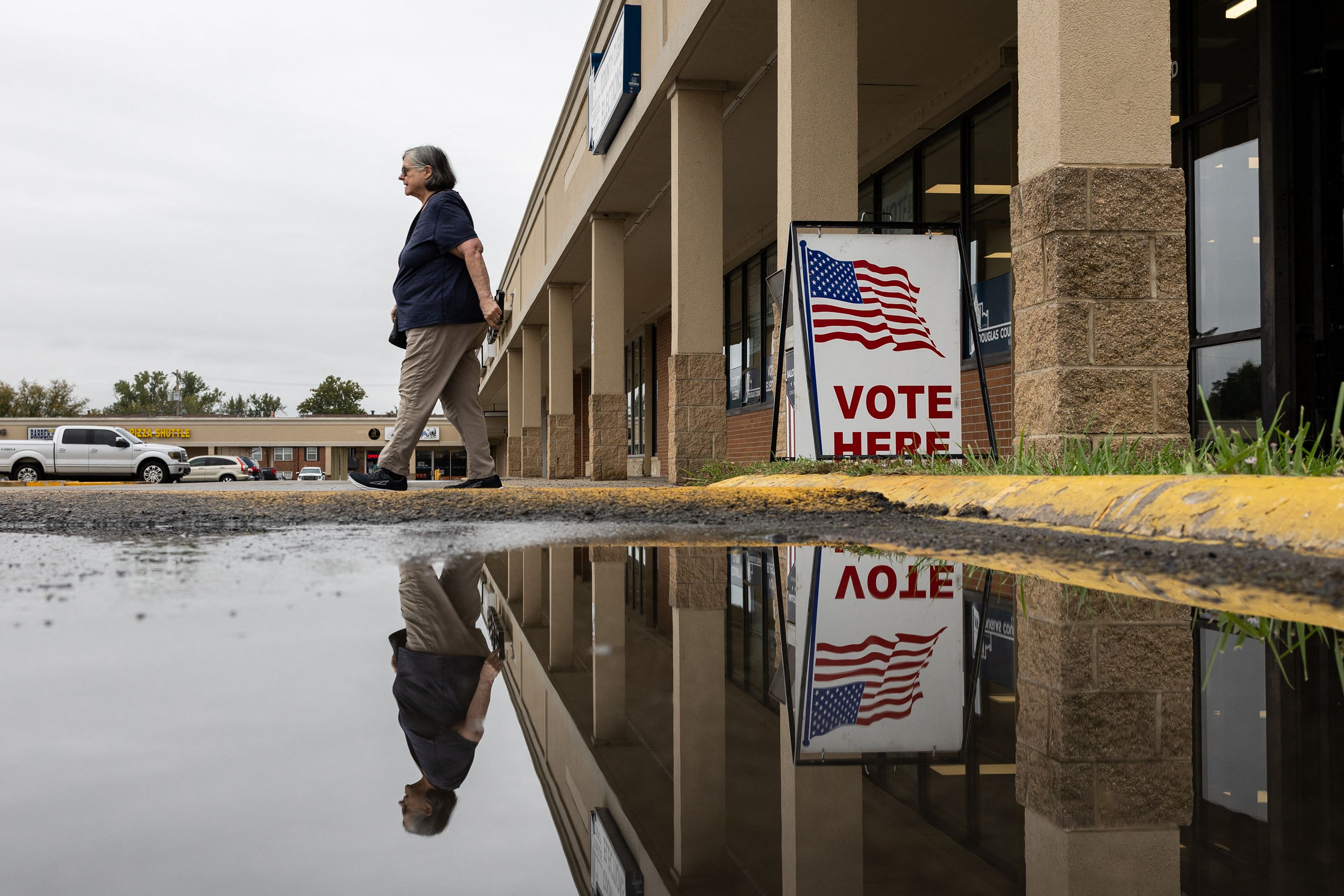 A woman leaves the polling station after casting her vote on the first day of in-person voting at the Douglas County Clerk Election Office in Lawrence, Kansas on October 14, 2026. Kansas has turned into a battleground state as Democrat candidate for US Senate Adam Hamilton, threatens to unseat Republican incumbent Roger Marshall.  Republicans have held this seat for 94 years. (Photo by Austin Johnson / AFP via Getty Images)