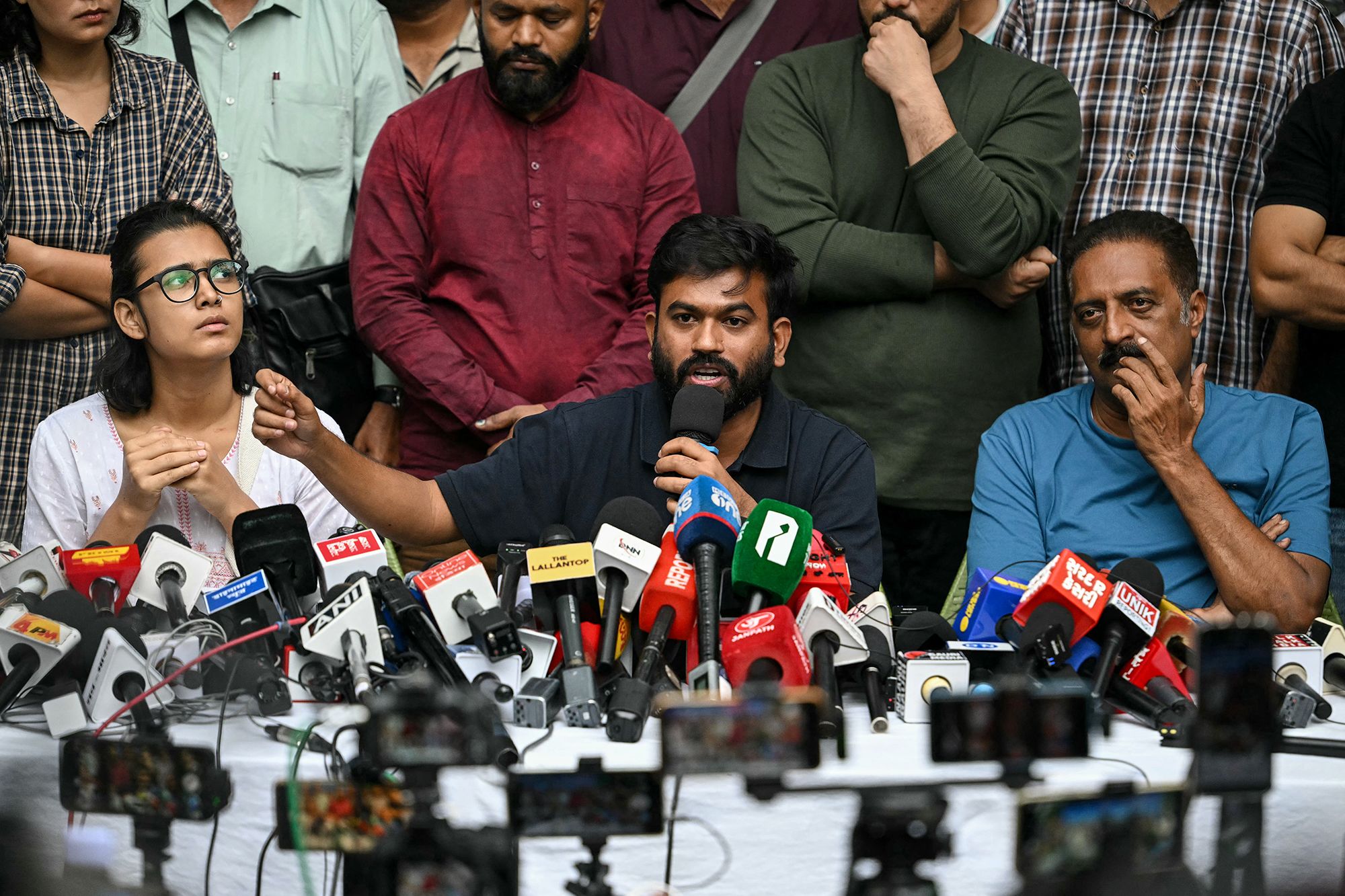 Cockroach Janta Party (CJP) founder Abhijeet Dipke, center, addresses media during a press conference in New Delhi, India, on Thursday.