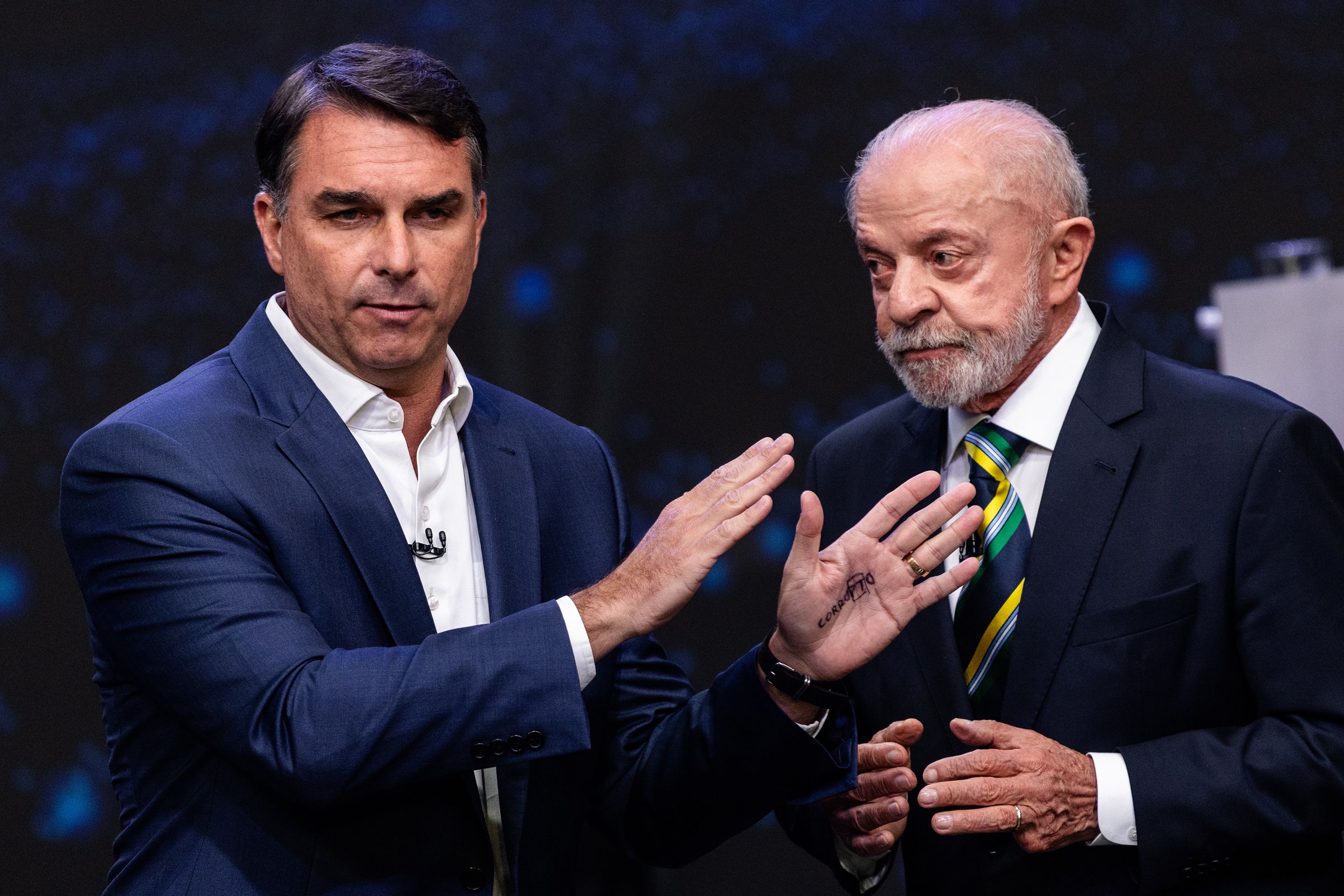 Flávio Bolsonaro, Brazilian presidential candidate, left, and Luiz Inácio Lula da Silva, Brazil's president, during the presidential debate at the TV Band studios in São Paulo, Brazil, on Sunday, Oct. 18.