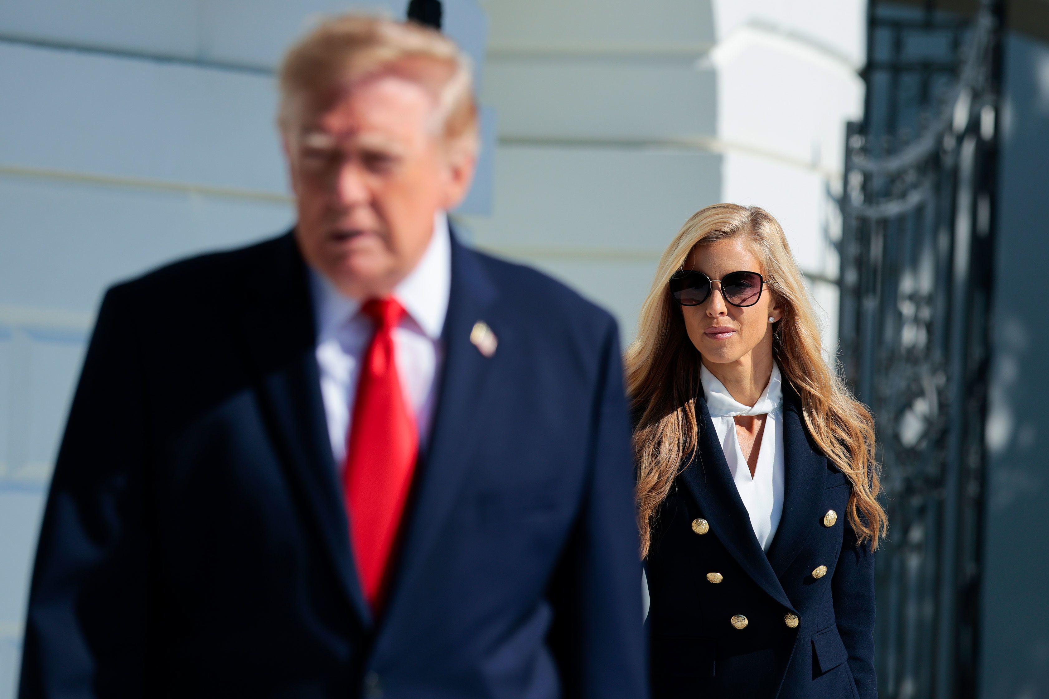 White House Press Secretary Katie Zacharia joins US President Donald Trump as he departs on the South Lawn of the White House on October 13 in Washington, DC.