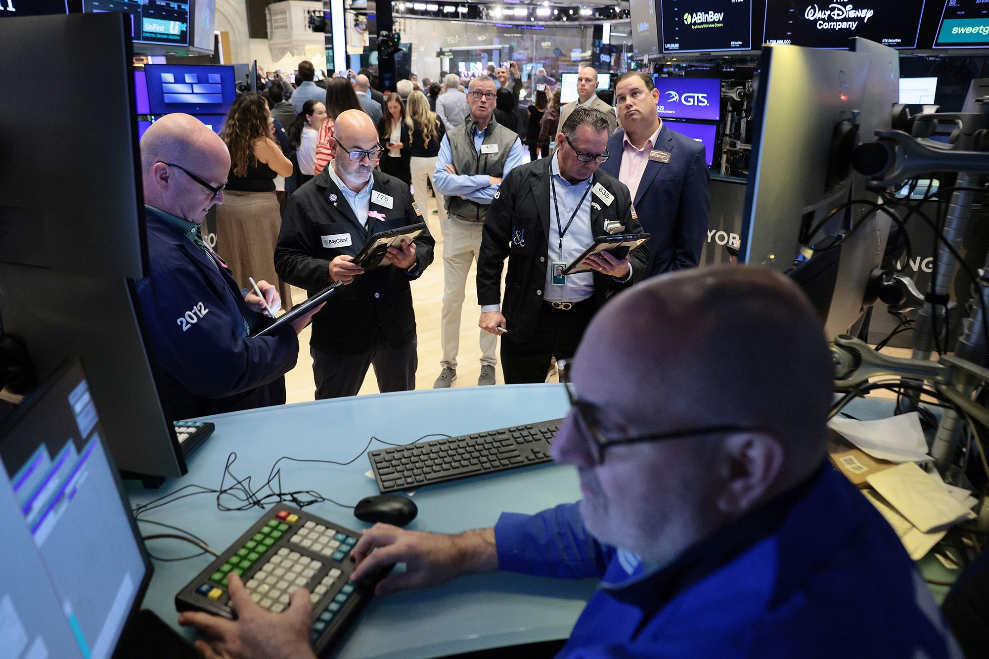 Traders work on the floor of the New York Stock Exchange during morning trading on October 14, 2026 in New York City.