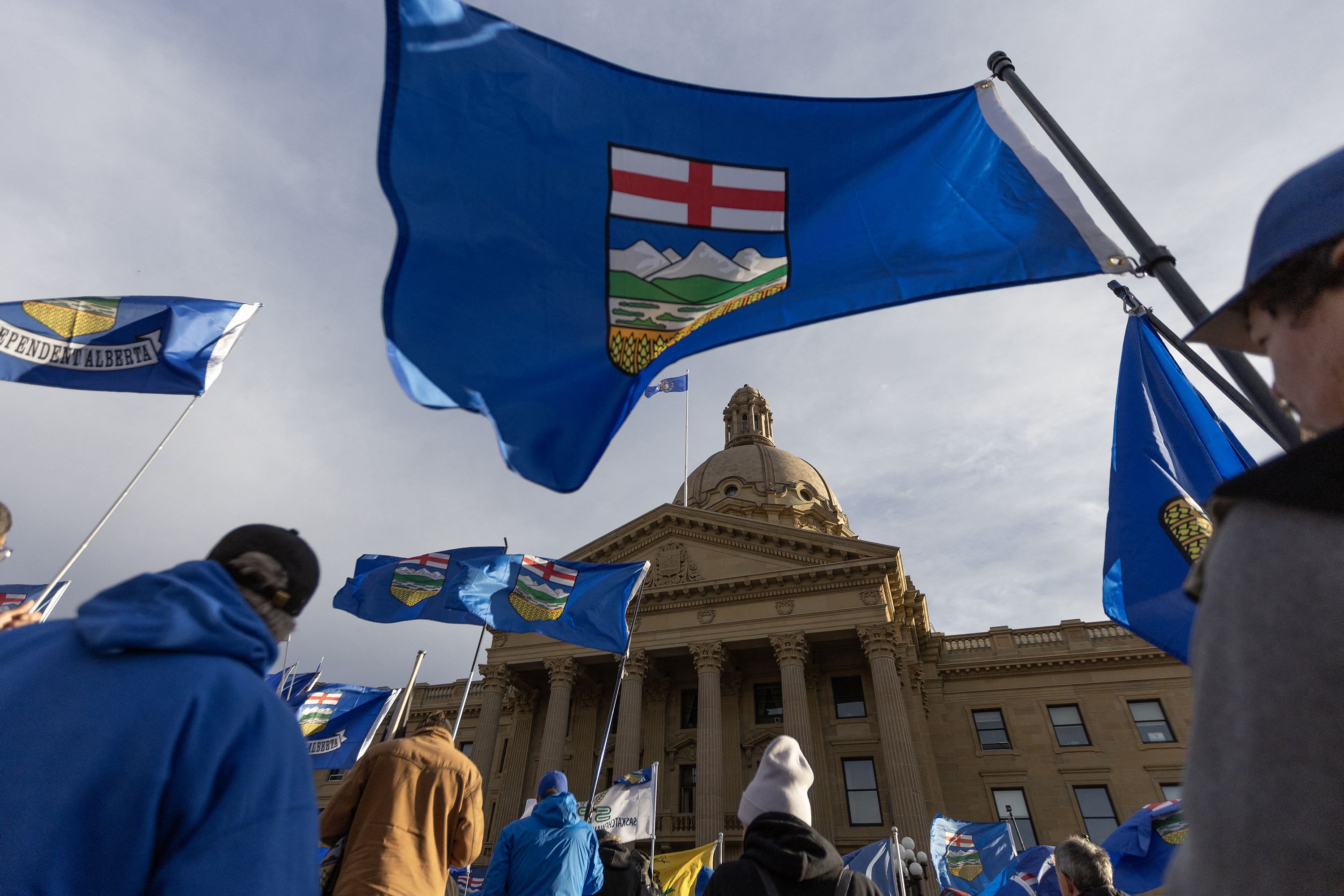 People fly flags during an Alberta Independence Rally in Edmonton, Alberta, Canada, on October 17.