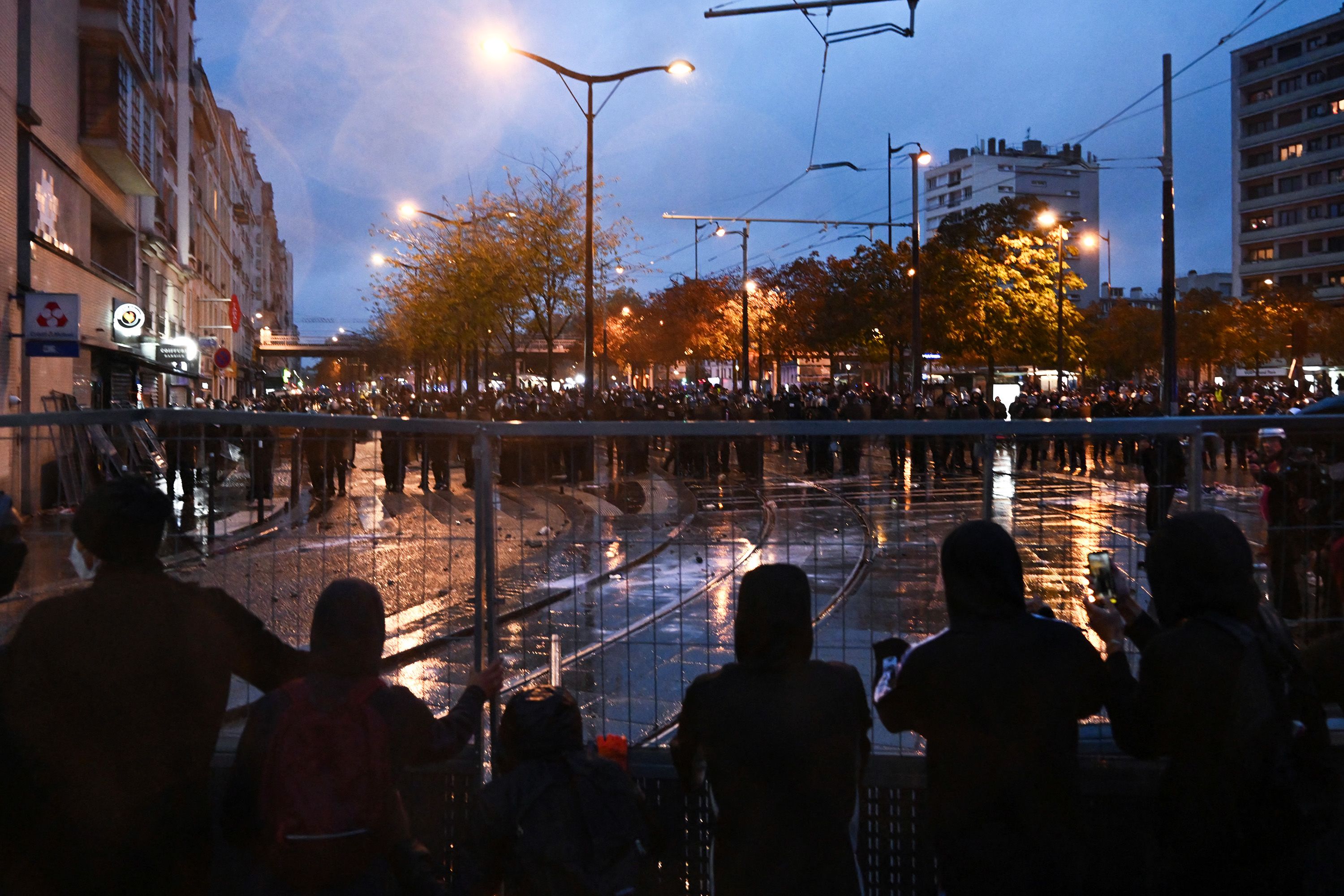 Protesters face police near Porte de Vincennes during a demonstration in favor of purchasing power, the protection of public services and fiscal and social justice in Paris on October 24.