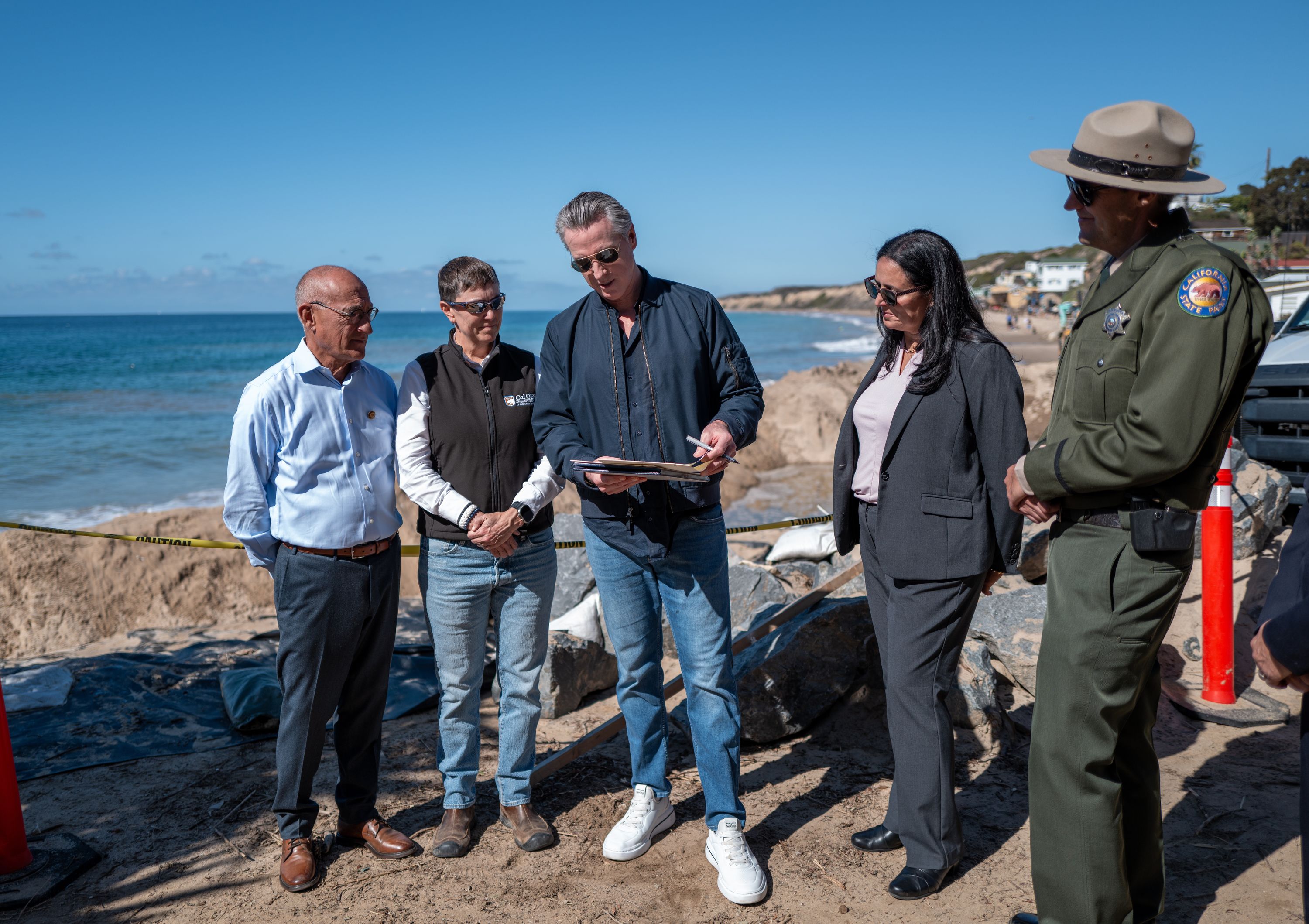 California Gov. Gavin Newsom signs an executive order to protect the state’s Pacific Coast Highway from El Ninõ-related storm impacts at Crystal Cove State Park in Orange County, California, on October 27.