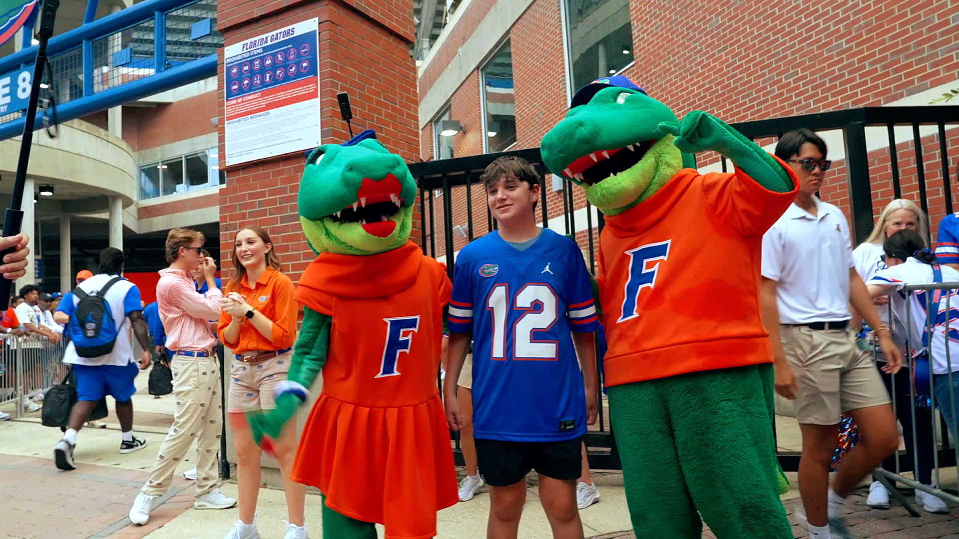 Jonah Blick gets his photo taken with a couple of Florida Gators mascots while attending a game at Ben Hill Griffin Stadium in Gainesville.