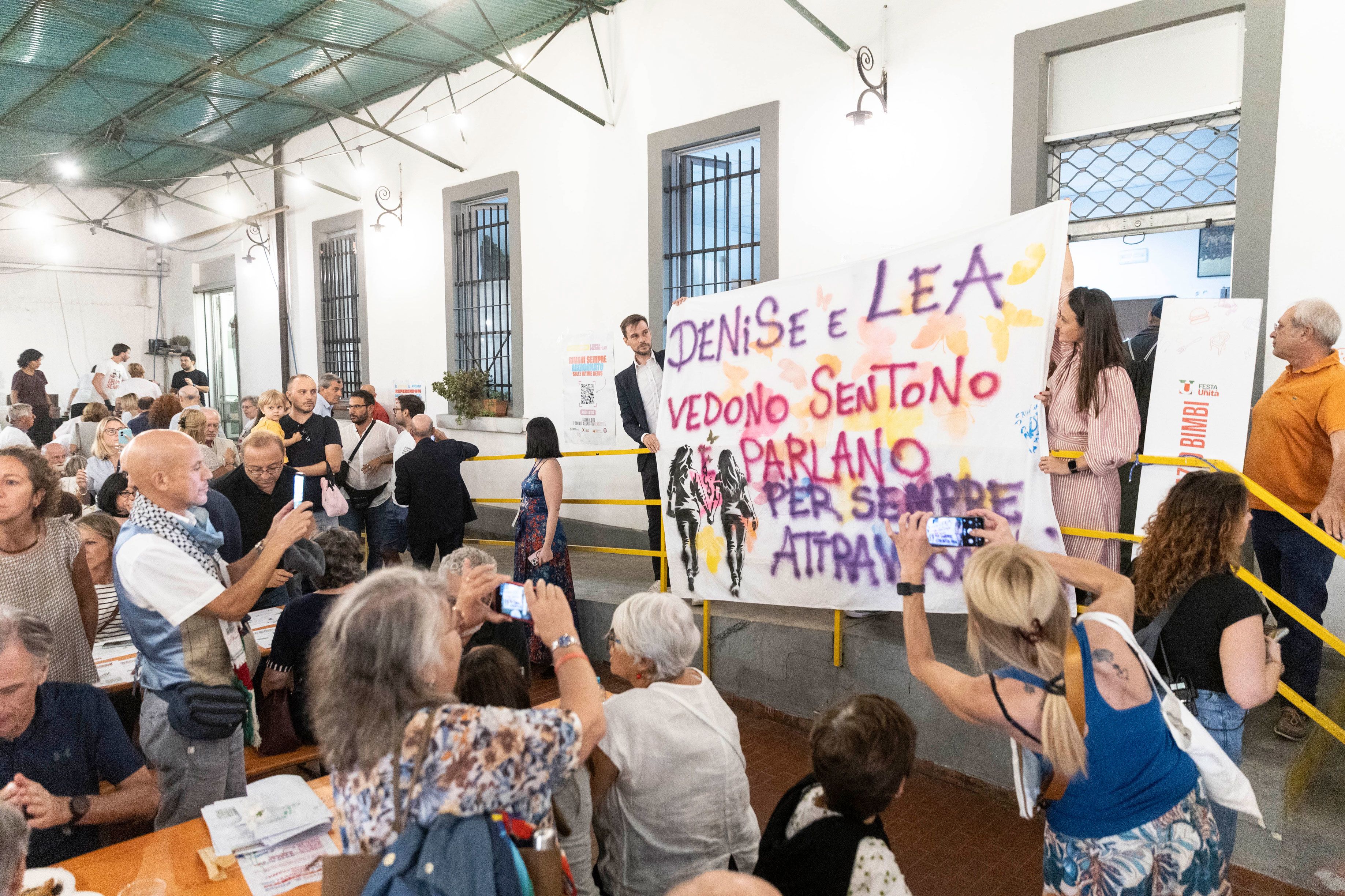 People hold a banner in memory of Denise Cosco and Lea Garofalo in Milan, Italy, on September 12.