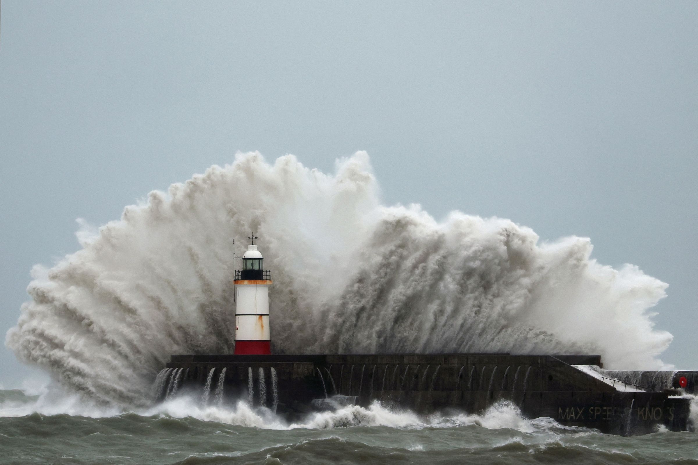 Waves crash over the lighthouse at Newhaven Harbour during Storm Austen in Newhaven, Britain, October 23, 2026.