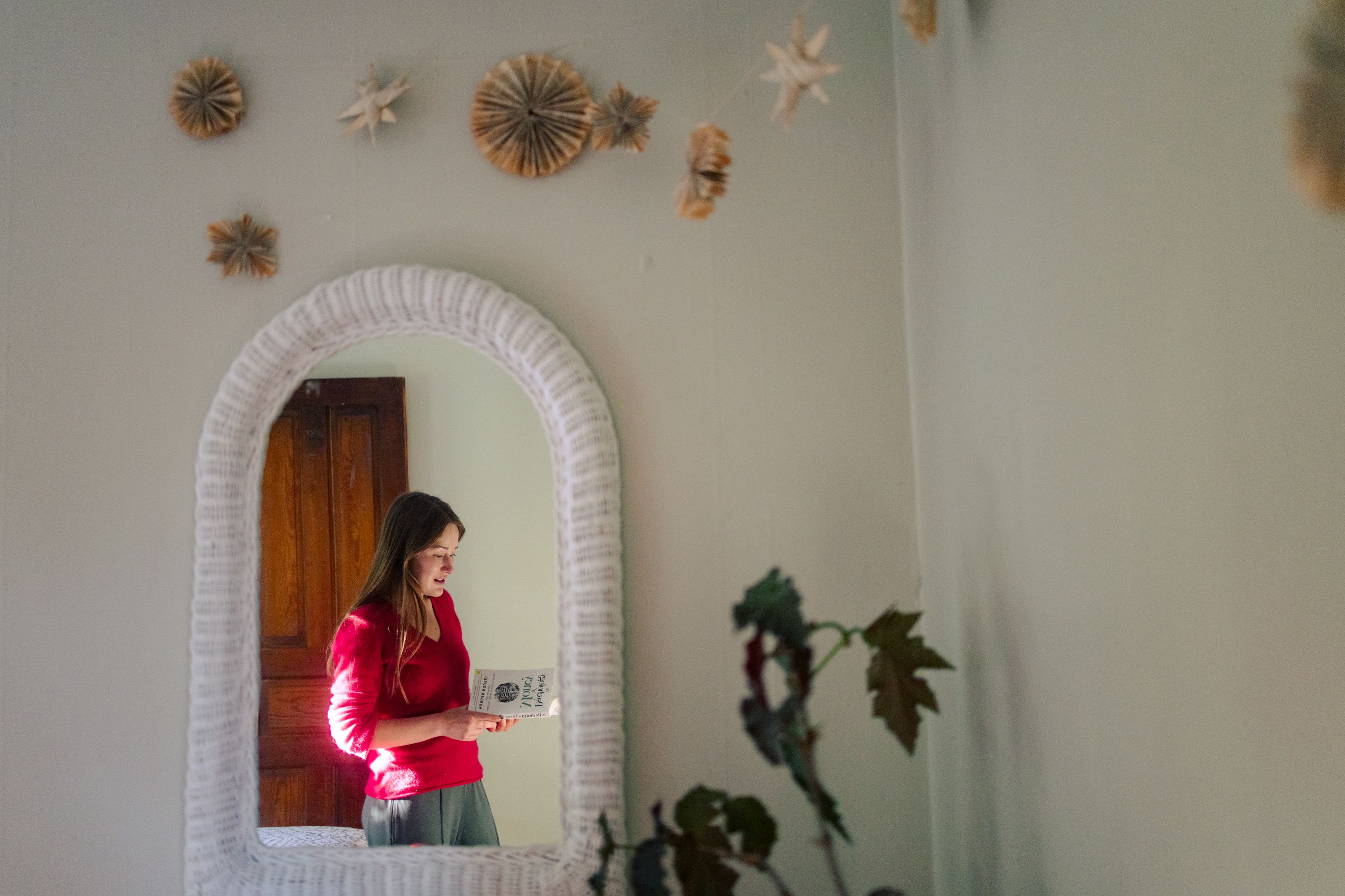 Abbey Graf is reading on the psychology of finances as she deals with financial anxiety, as seen in her home in Madison, Wisconsin, on May 11, 2026. While working from home, she also balances managing her home, cooking meals, and budgeting tightly.