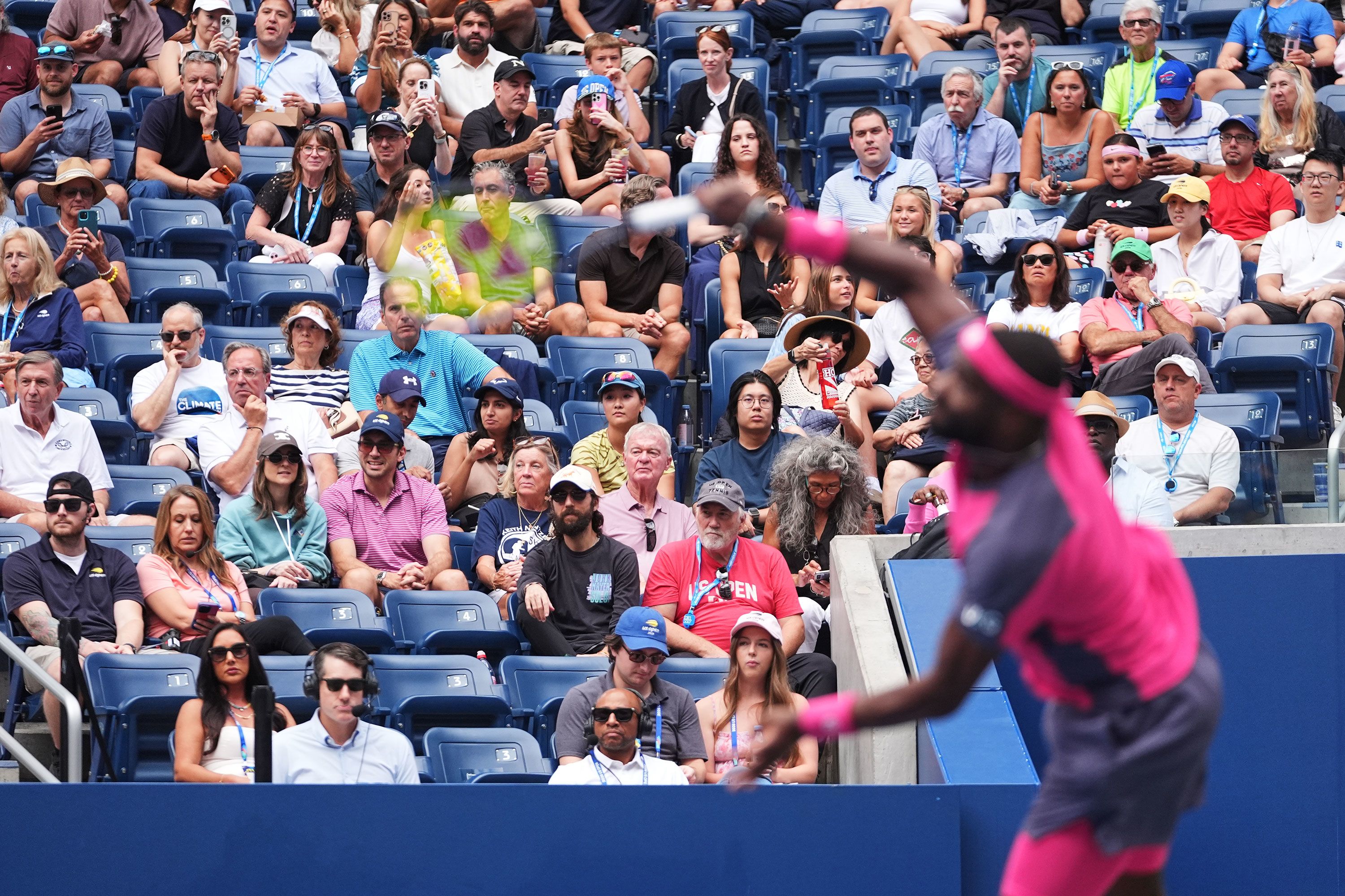 Fans watch as Frances Tiafoe serves to Daniil Medvedev on Sunday. Crowds have been the talk of the tournament as influencers are noticed by fans and players alike.