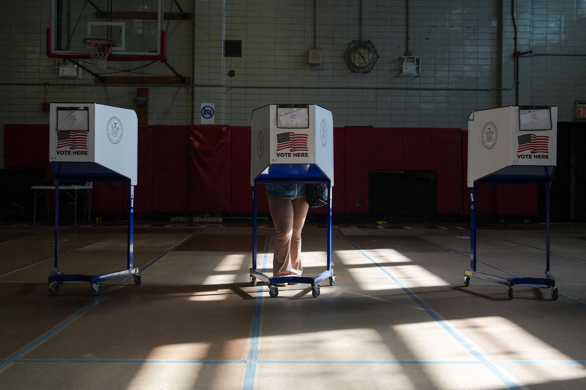 A voter casts their ballot on the first day of early voting for the US midterm elections in the Brooklyn borough of New York City, on October 24, 2026.