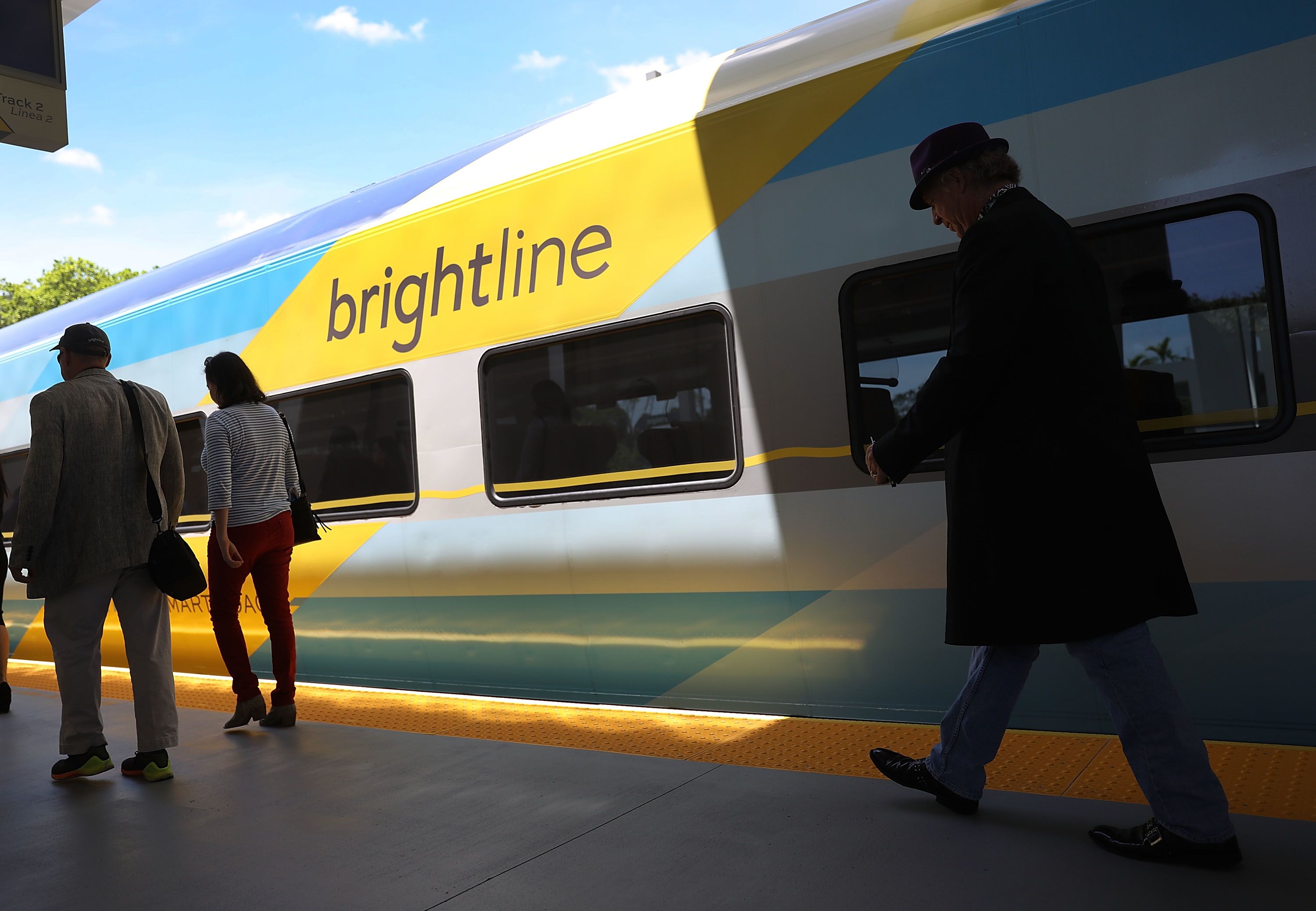 Passengers load up on the Brightline train at the Fort Lauderdale station during the inaugural trip from Miami to West Palm Beach in May 2018.