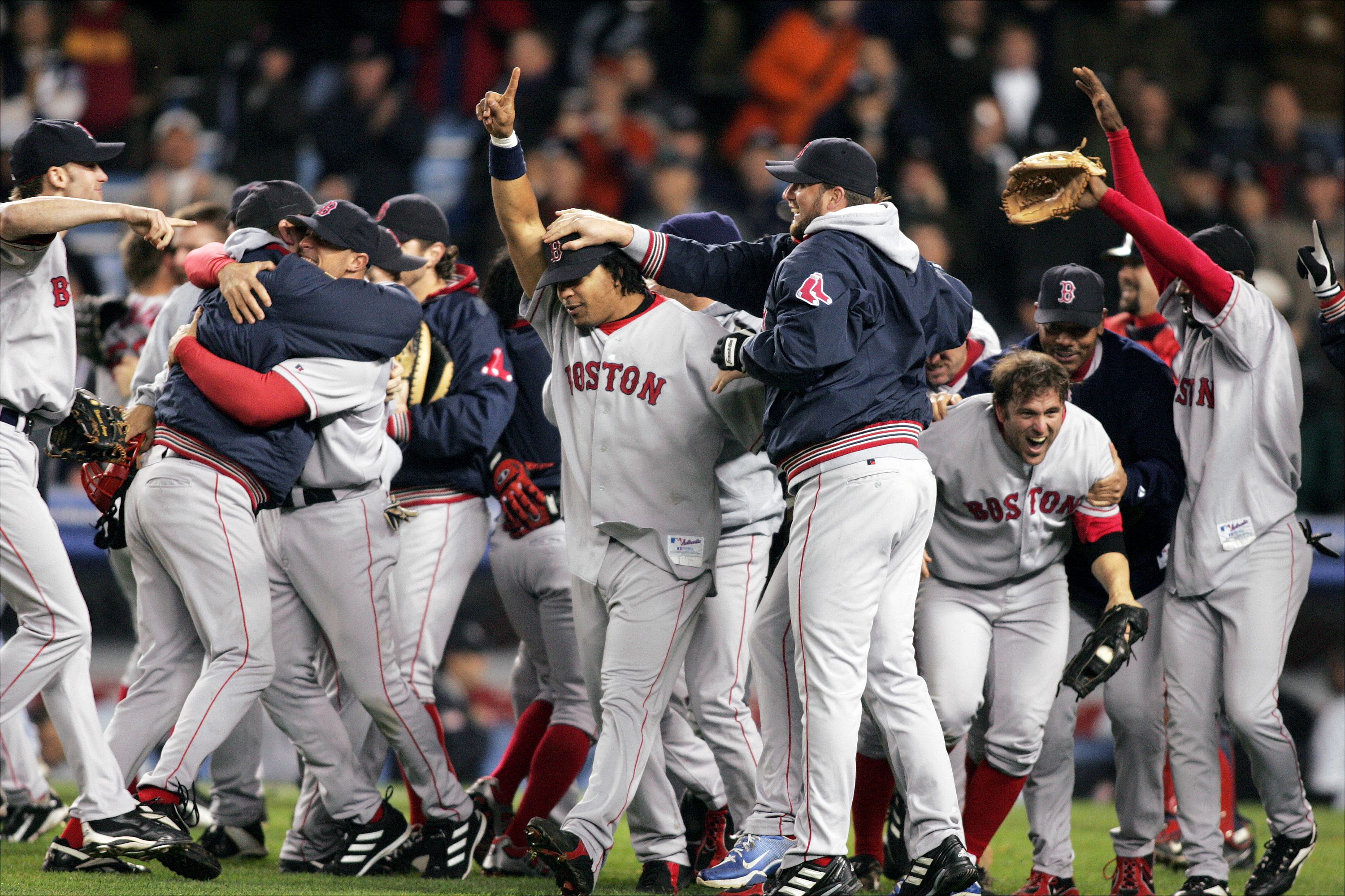Manny Ramirez (center) points out that the Boston Red Sox are No. 1 as players celebrate on the field after their 10-3 victory over the New York Yankees in Game 7 of the American League Championship Series at Yankee Stadium. In an astounding comeback, the Bosox became the first team in baseball history to win a best-of-seven series after losing the first three games. Now, they go on to the World Series.