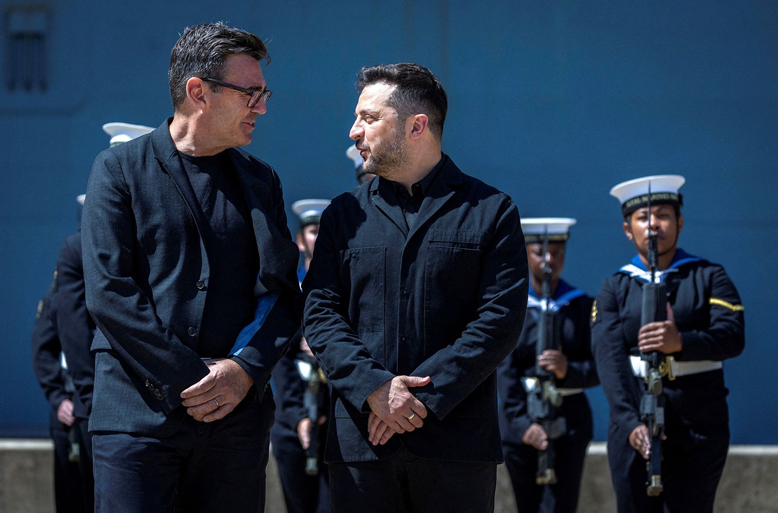 British Prime Minister Andy Burnham interacts with the president of Ukraine, Volodymyr Zelenskiy, during their visit to Portsmouth Naval Base to meet UK and Ukrainian troops, July 27, 2026.