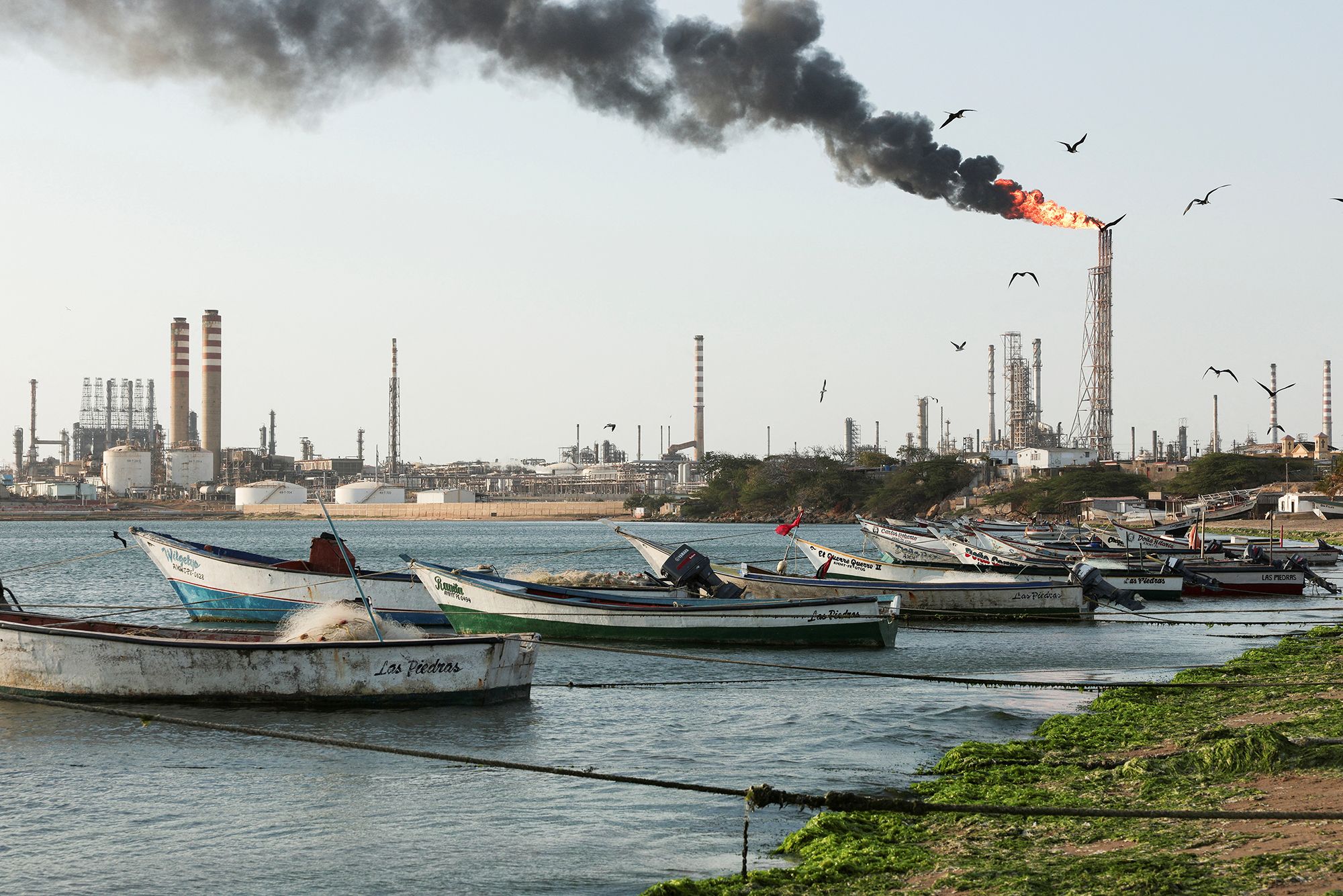 Fishing boats are moored on the shoreline near the Cardon refinery in Punta Cardon, Venezuela, on May 6, 2026.