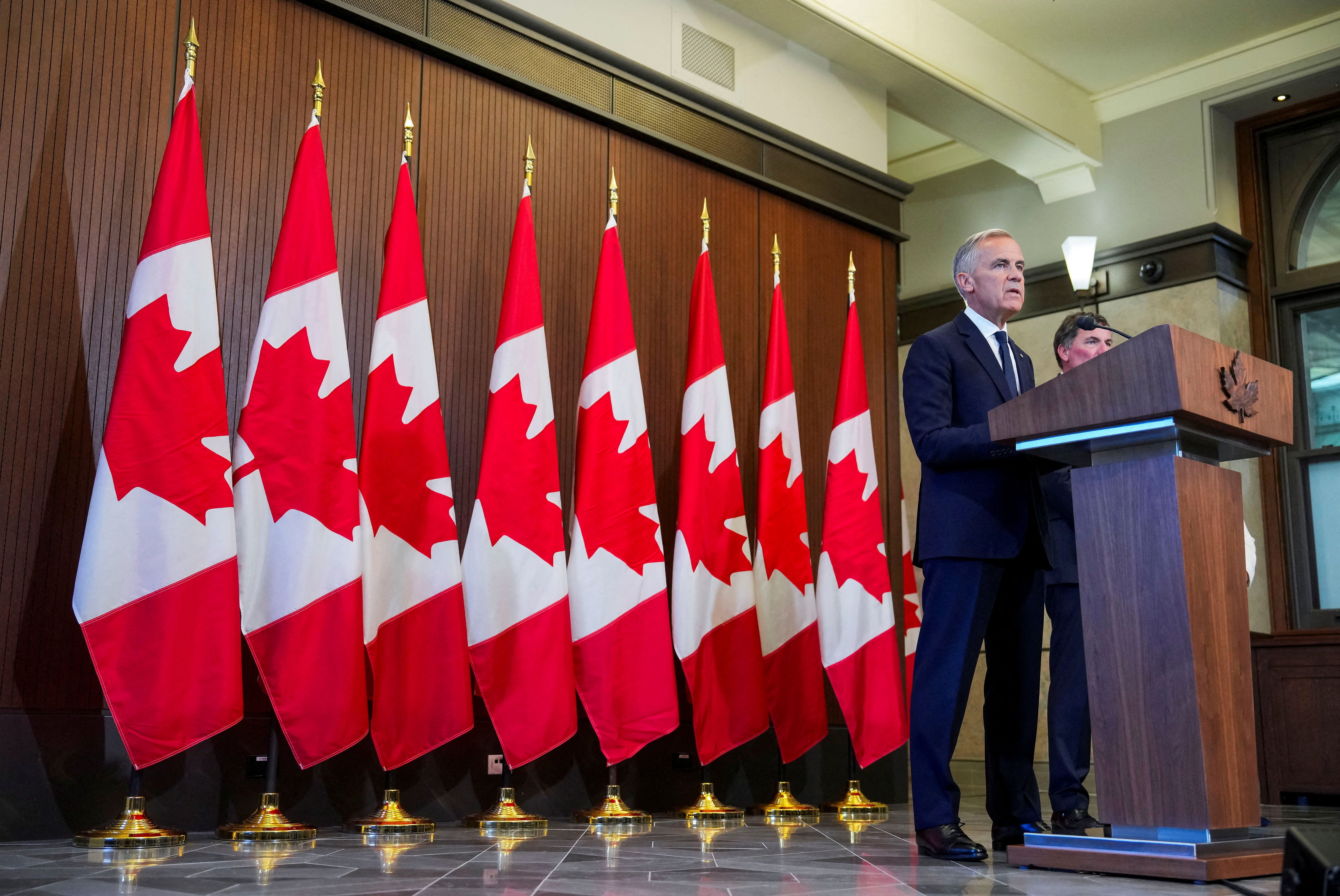 Canada’s Prime Minister Mark Carney speaks with reporters after he suspended trade negotiations with the United States, in Ottawa, Ontario, Canada on Saturday.