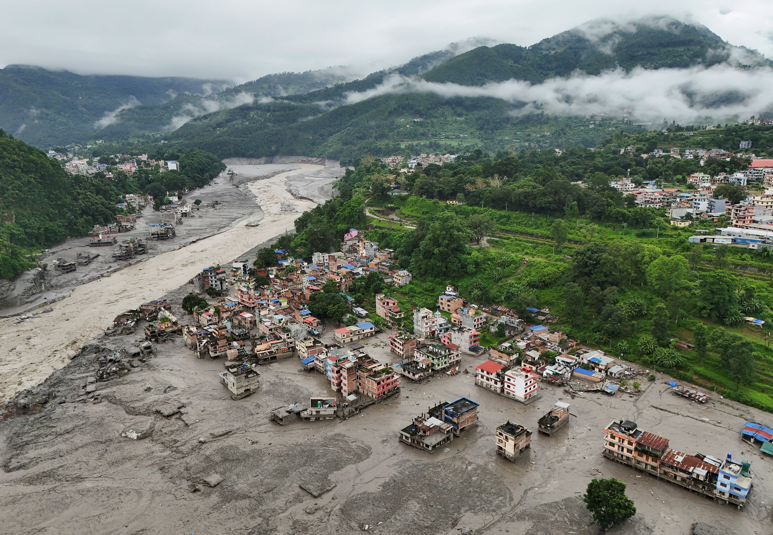 A drone view shows mud covering buildings and property following a flash flood in Trishuli, Nuwakot district, Nepal, August 27, 2026.