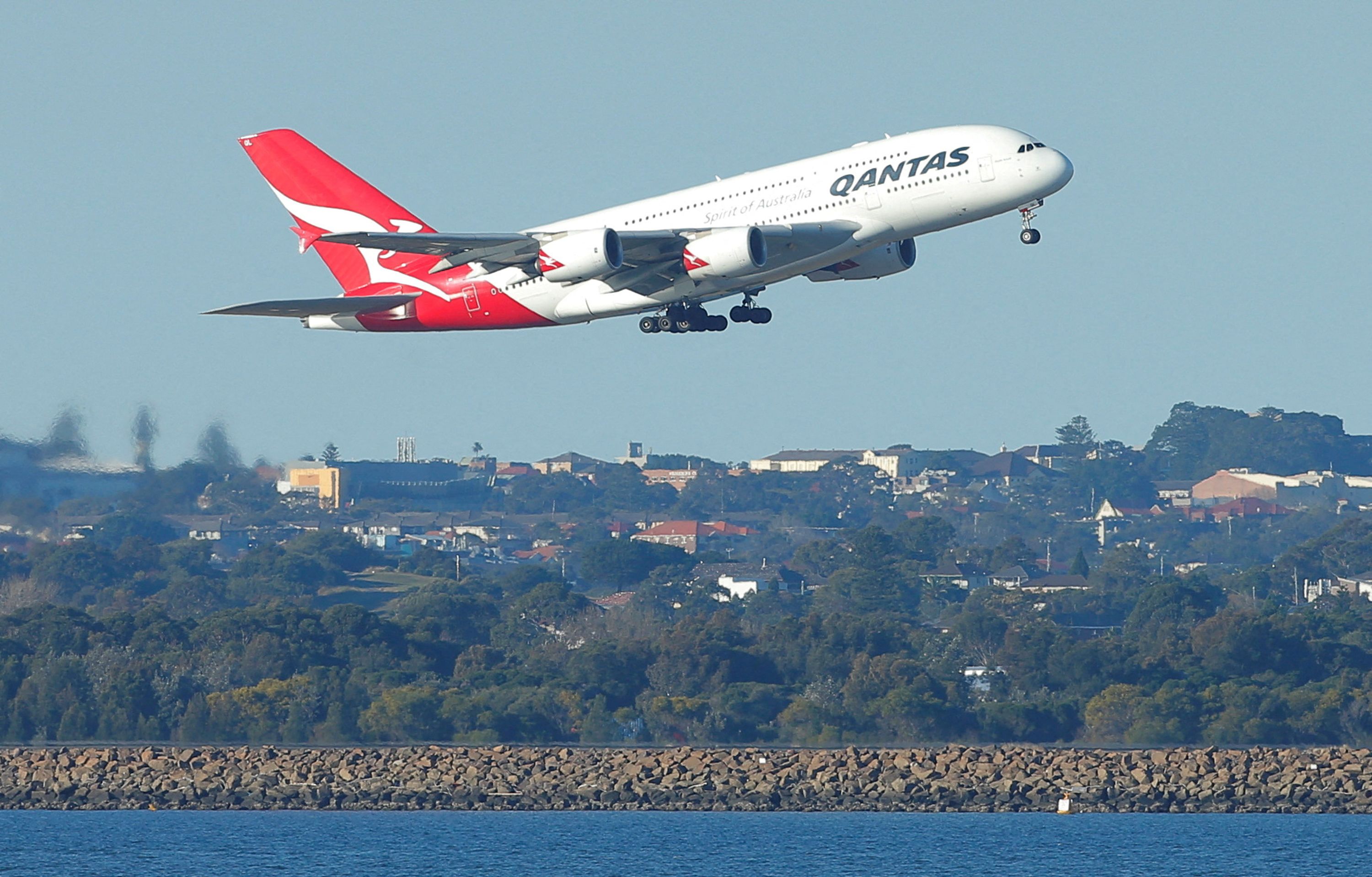 FILE PHOTO: FILE PHOTO: Qantas flight QF1, an Airbus A380-800 aircraft, takes off from Sydney International Airport en route to Dubai, above Botany Bay, in Australia August 22, 2017. REUTERS/Jason Reed/File Photo