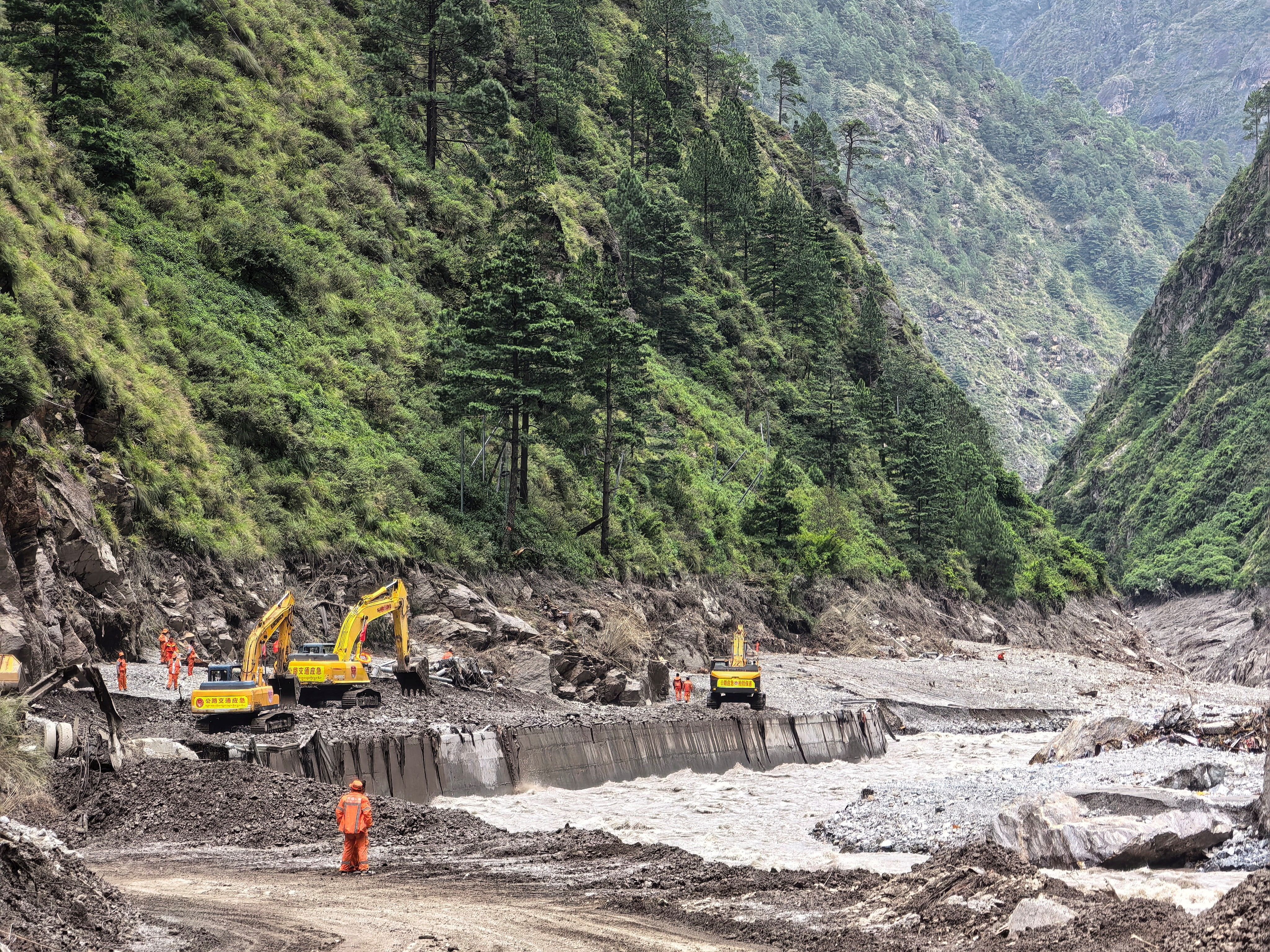 Rescue workers repair a damaged road leading to Tibet's Gyirong port on August 27.