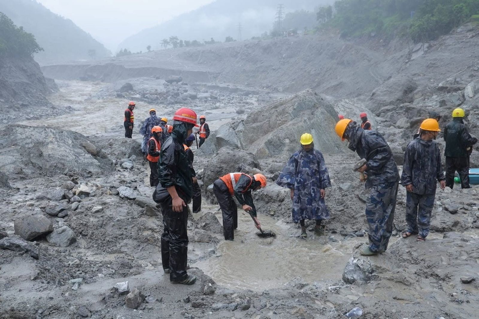 An undated handout photo of rescue workers taking part in a rescue operation near the tunnel of the Trishuli 3A Hydropower Project, following deadly flash floods and mudslides, in Rasuwa, Nepal.