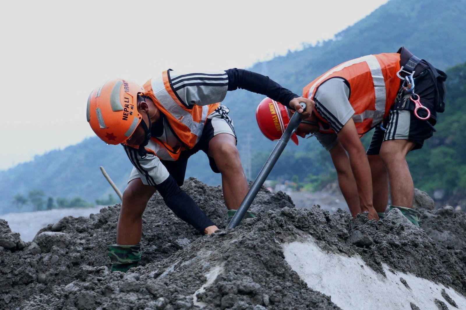 Rescue workers takes part in a rescue operation near the tunnel of the Trishuli 3A Hydropower Project in Rasuwa, Nepal on Sunday.