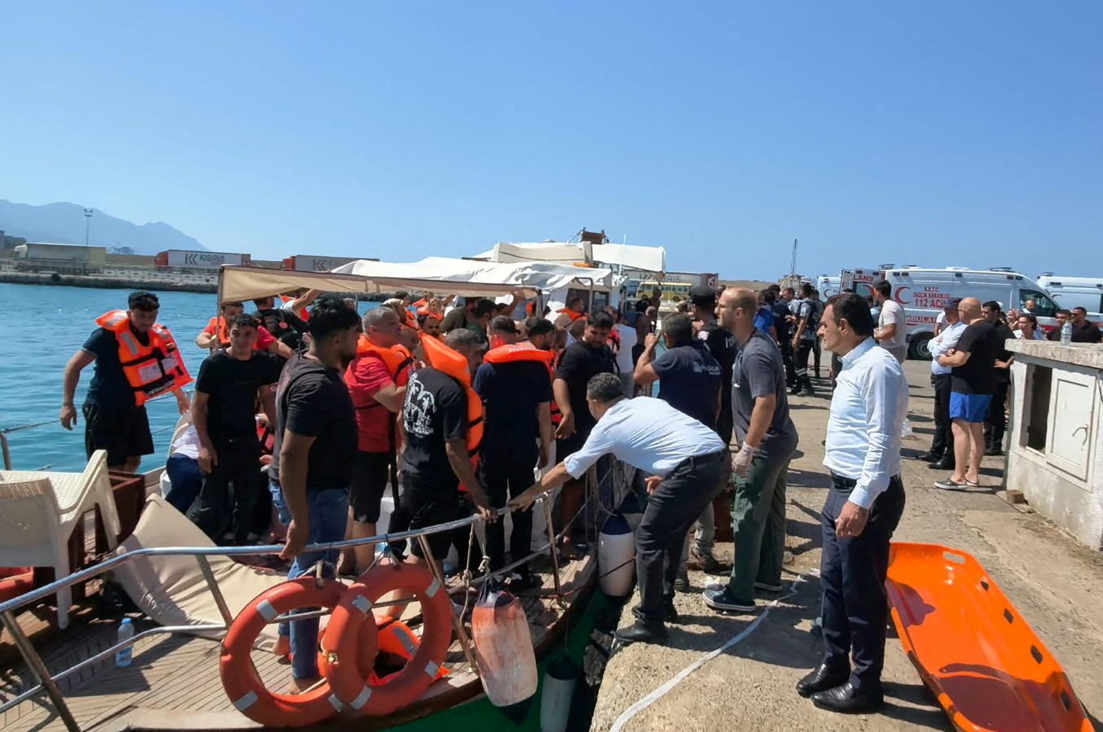 Survivors arrive on shore after being rescued from the sea following a boat capsize off Kyrenia, northern Cyprus, August 30, 2026.
