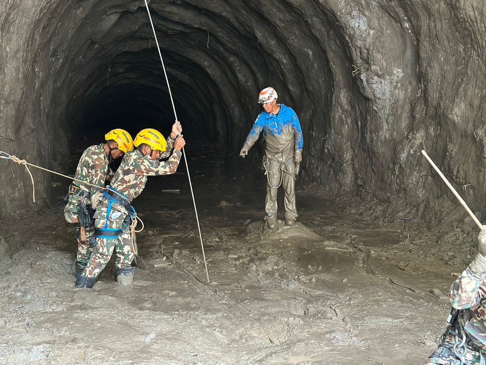 Nepal army soldiers work during a search and rescue operation outside a tunnel near the Hydropower Project sites in Rasuwa district, Nepal, in this handout obtained on September 2.