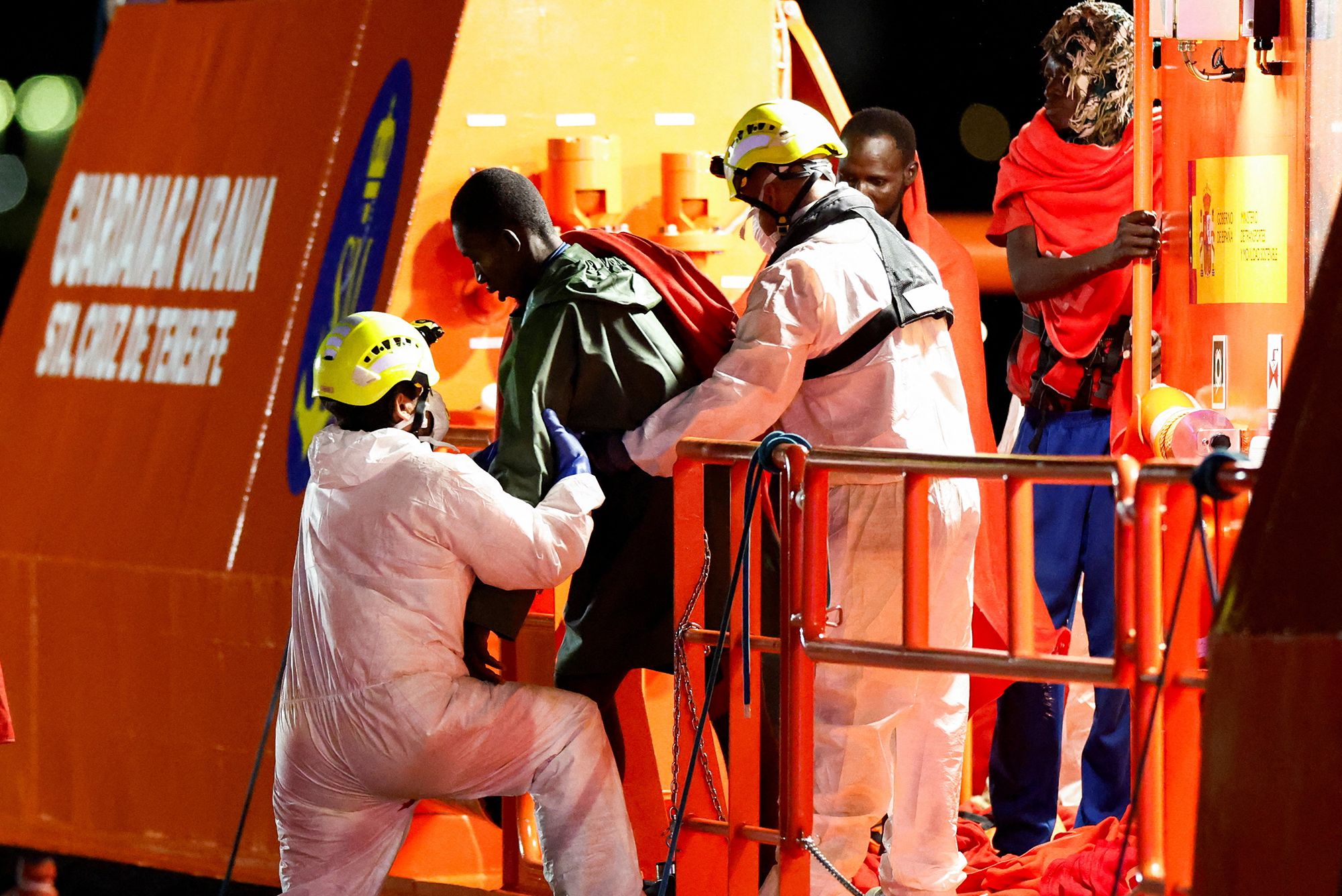 Rescuers help a man, rescued after nearly a month at sea, disembark from a Spanish coast guard vessel at the port of Arguineguin, on the island of Gran Canaria, Spain, on September 3.