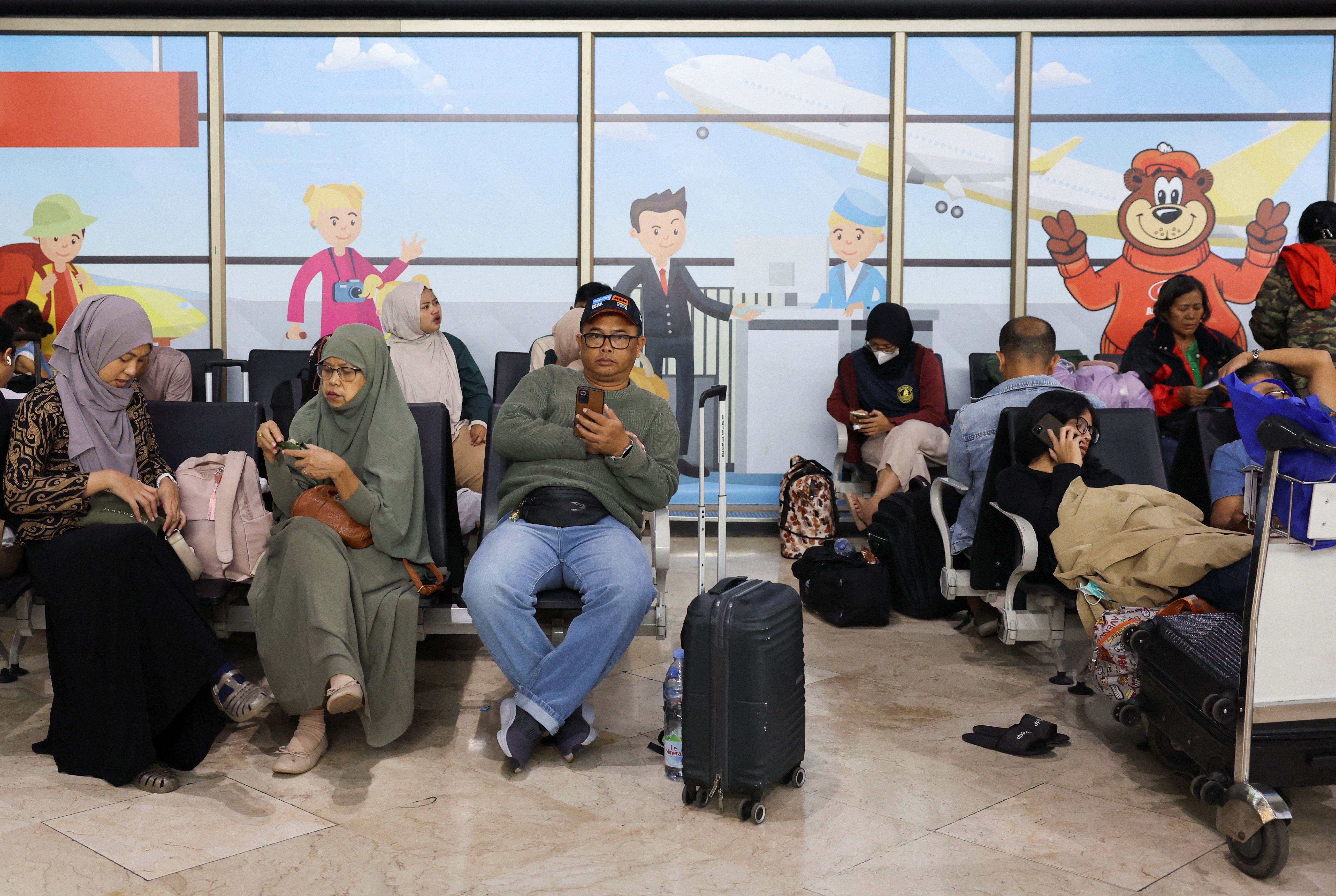 Stranded passengers wait at terminal as Soekarno Hatta International Airport closed its operations due to the eruption of the Mount Anak Krakatau volcano, in Tangerang, near Jakarta, Indonesia, on September 6, 2026.