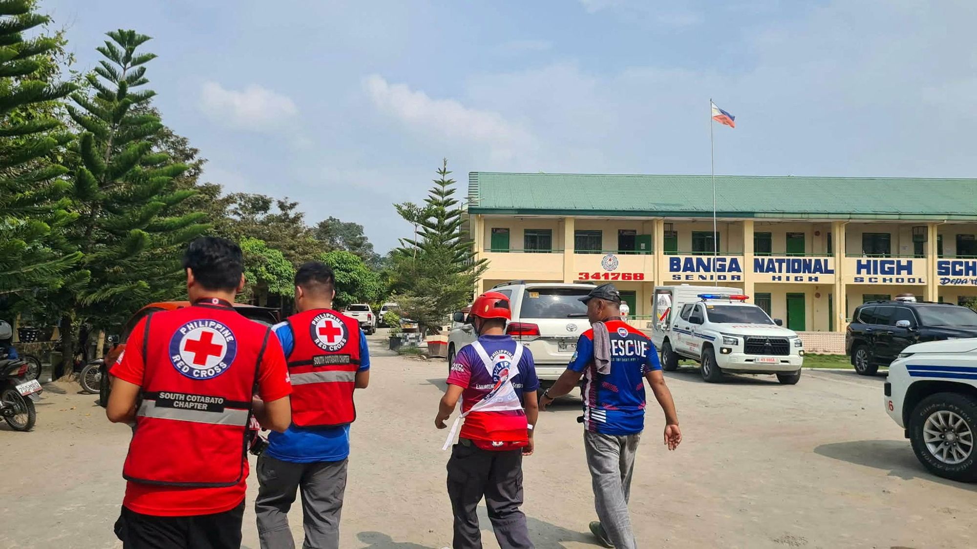 Emergency personnel walk at a site of a deadly shooting at a school in Banga, South Cotabato, Philippines.