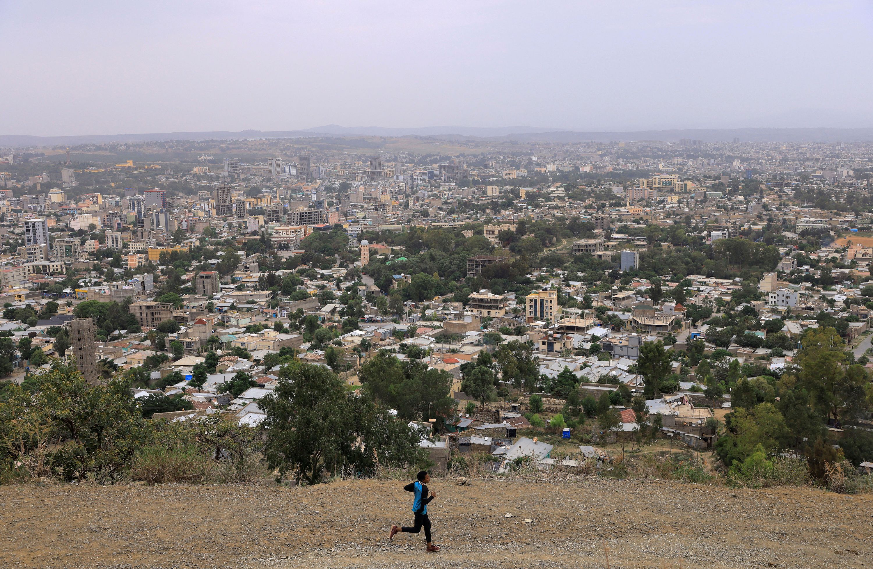 FILE PHOTO: A man runs in front of the cityscape of Mekele, Tigray Region, Ethiopia, on June 25, 2023.