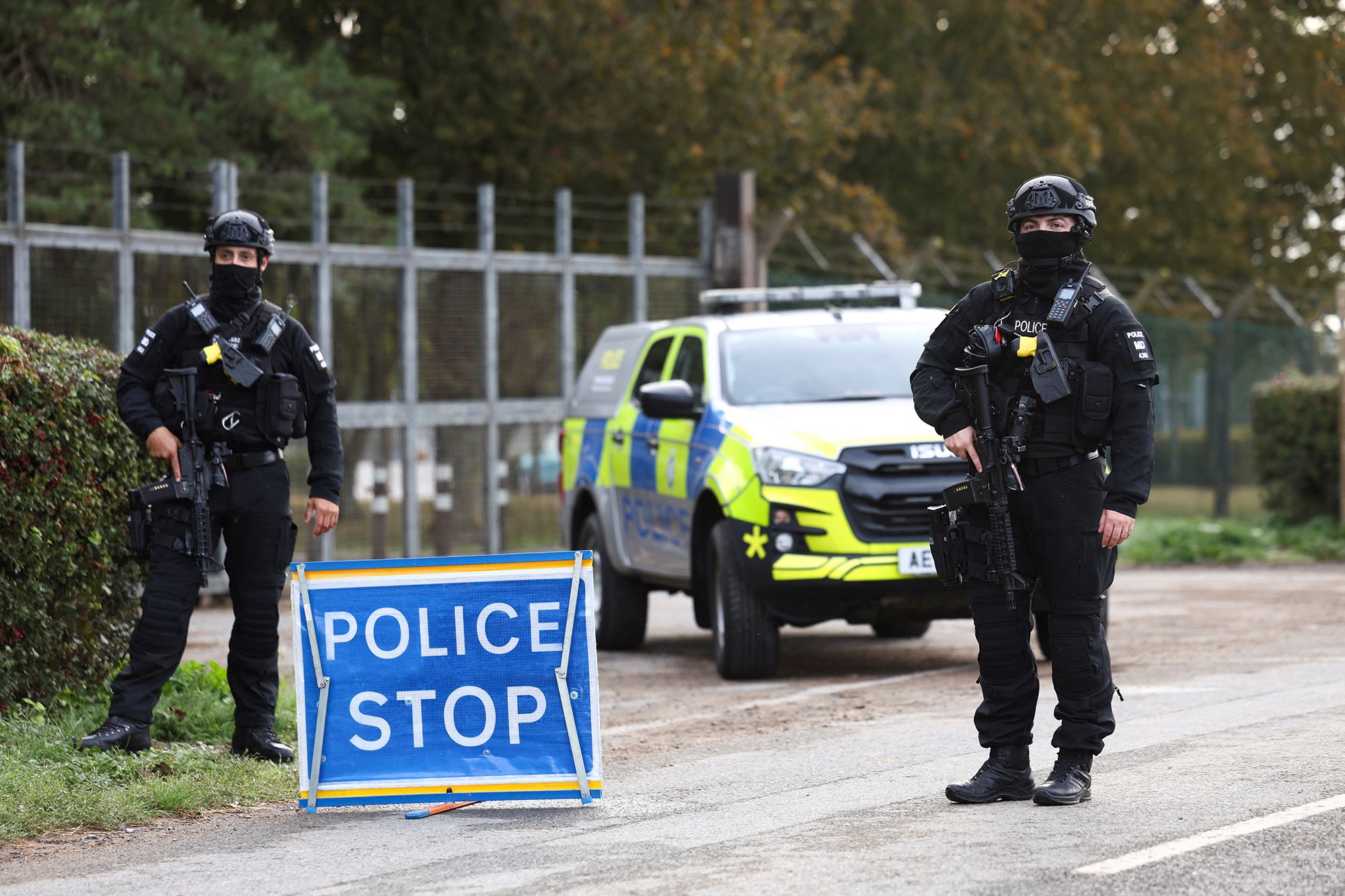 Armed police officers stand guard on a road outside the perimeter of the RAF Fairford airbase on Monday, September 28.