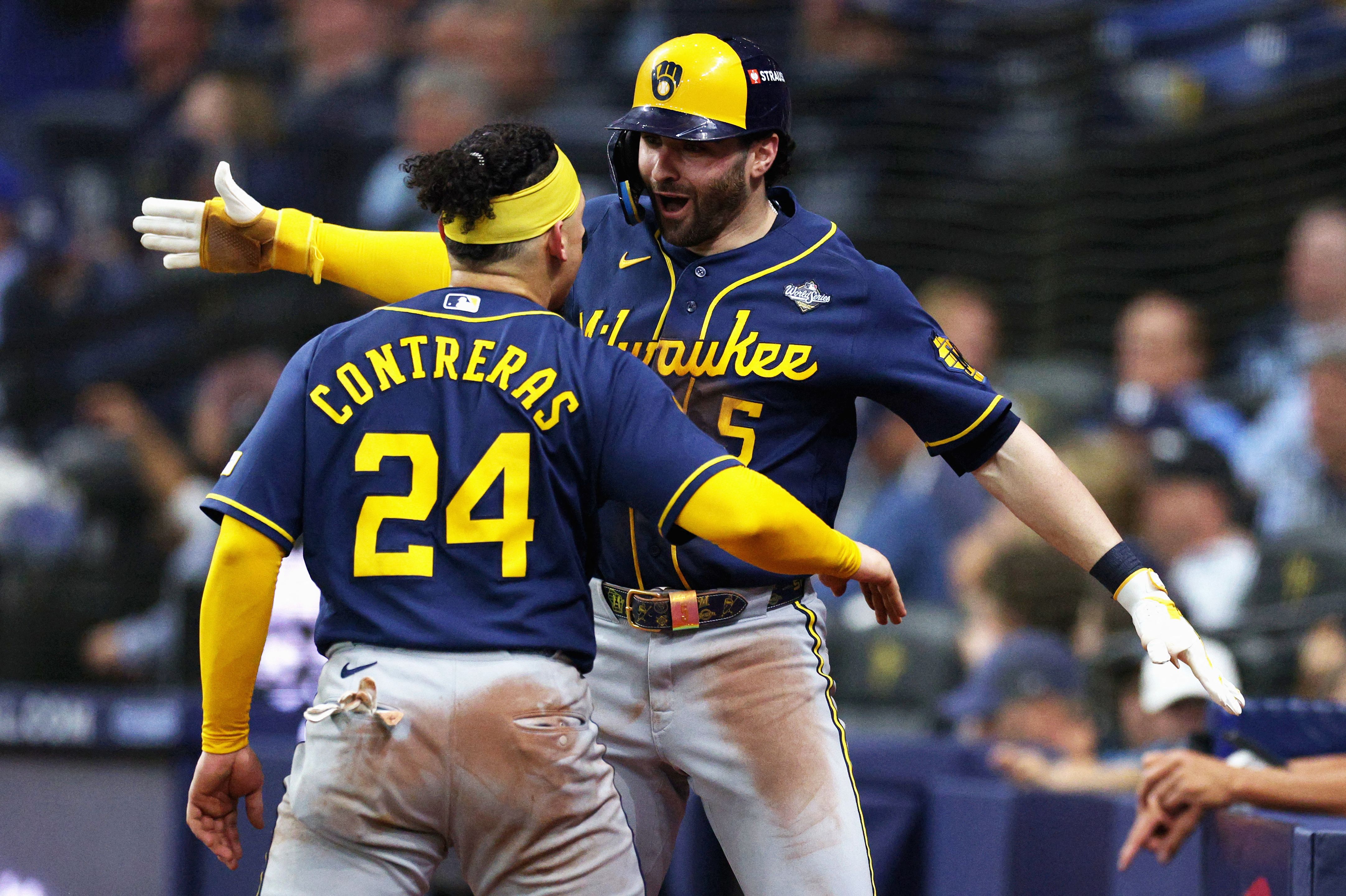 Milwaukee's William Contreras and Garrett Mitchell celebrate during an eight-run fifth inning.