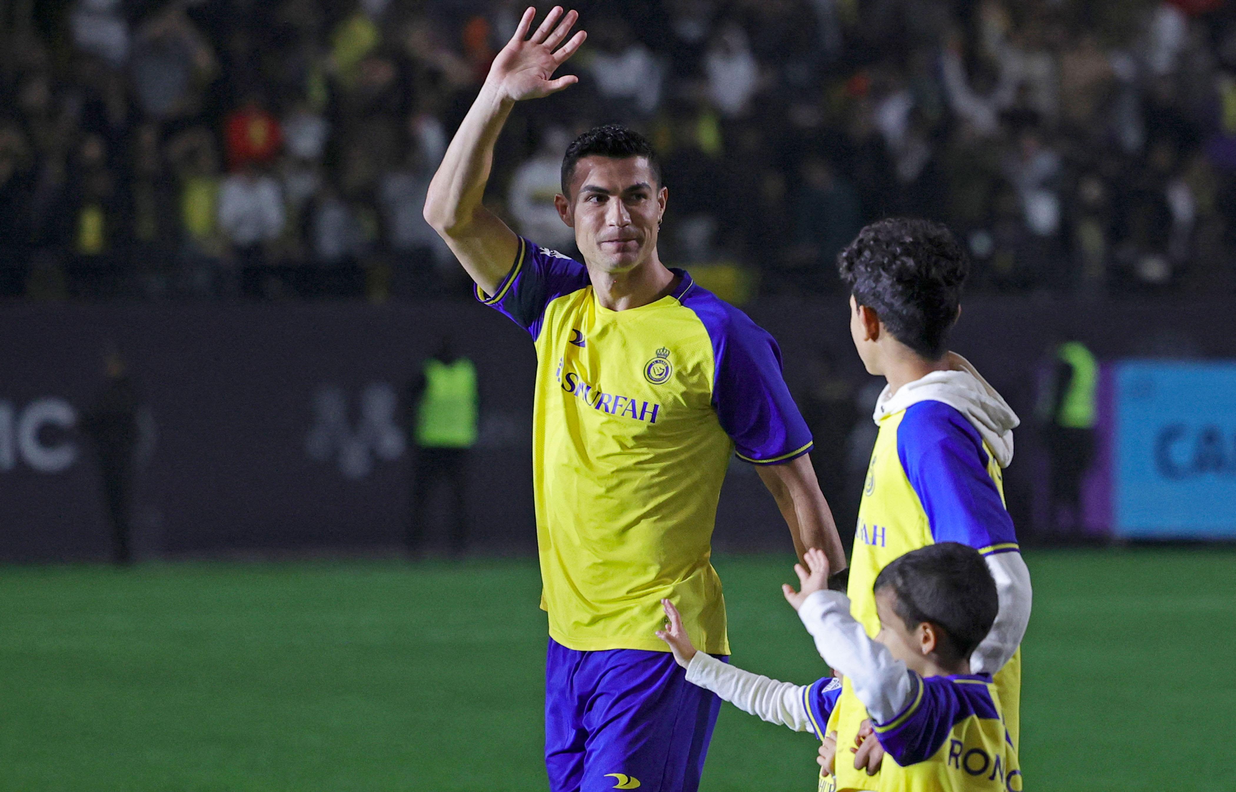 Portuguese forward Cristiano Ronaldo greets the crowd alongside his children at the Mrsool Park Stadium in the Saudi capital Riyadh on January 3.