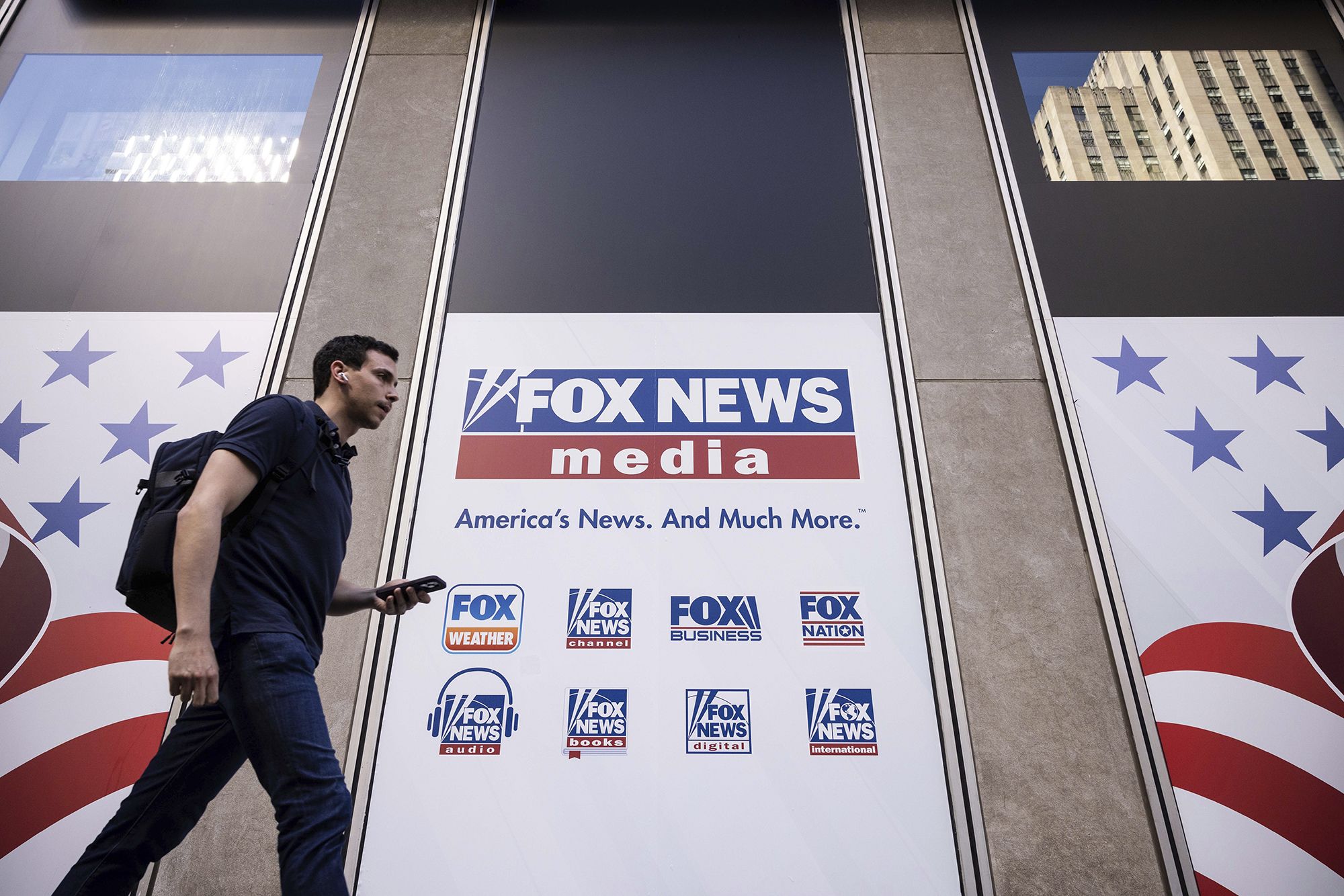 A person walks past the Fox News Headquarters in New York, Wednesday, April. 12, 2023. 
